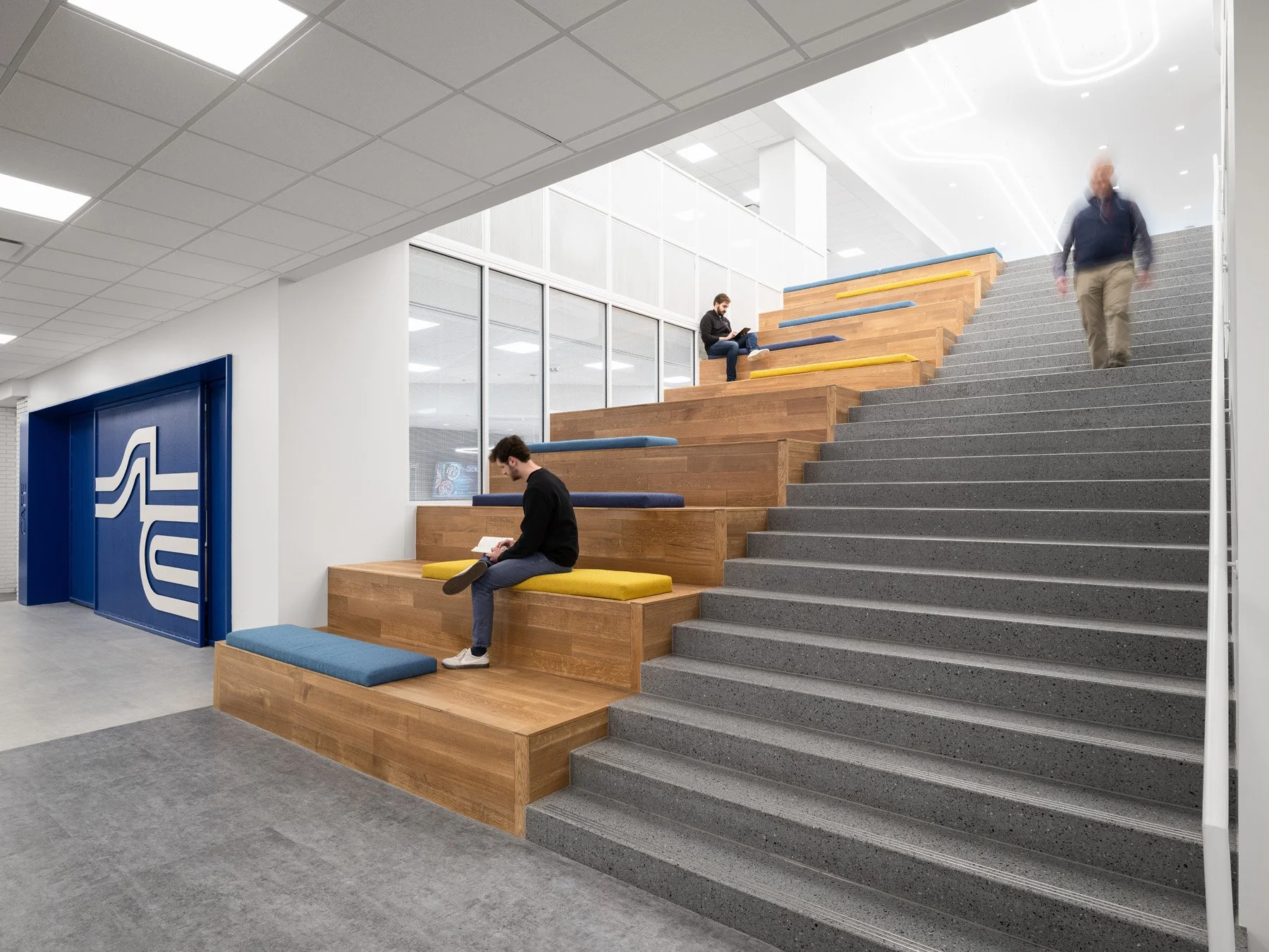 STLCC Florissant Valley Student Center assembly stair and blue logo wall by JEMA, Ferguson Missouri - architectural photographer St. Louis