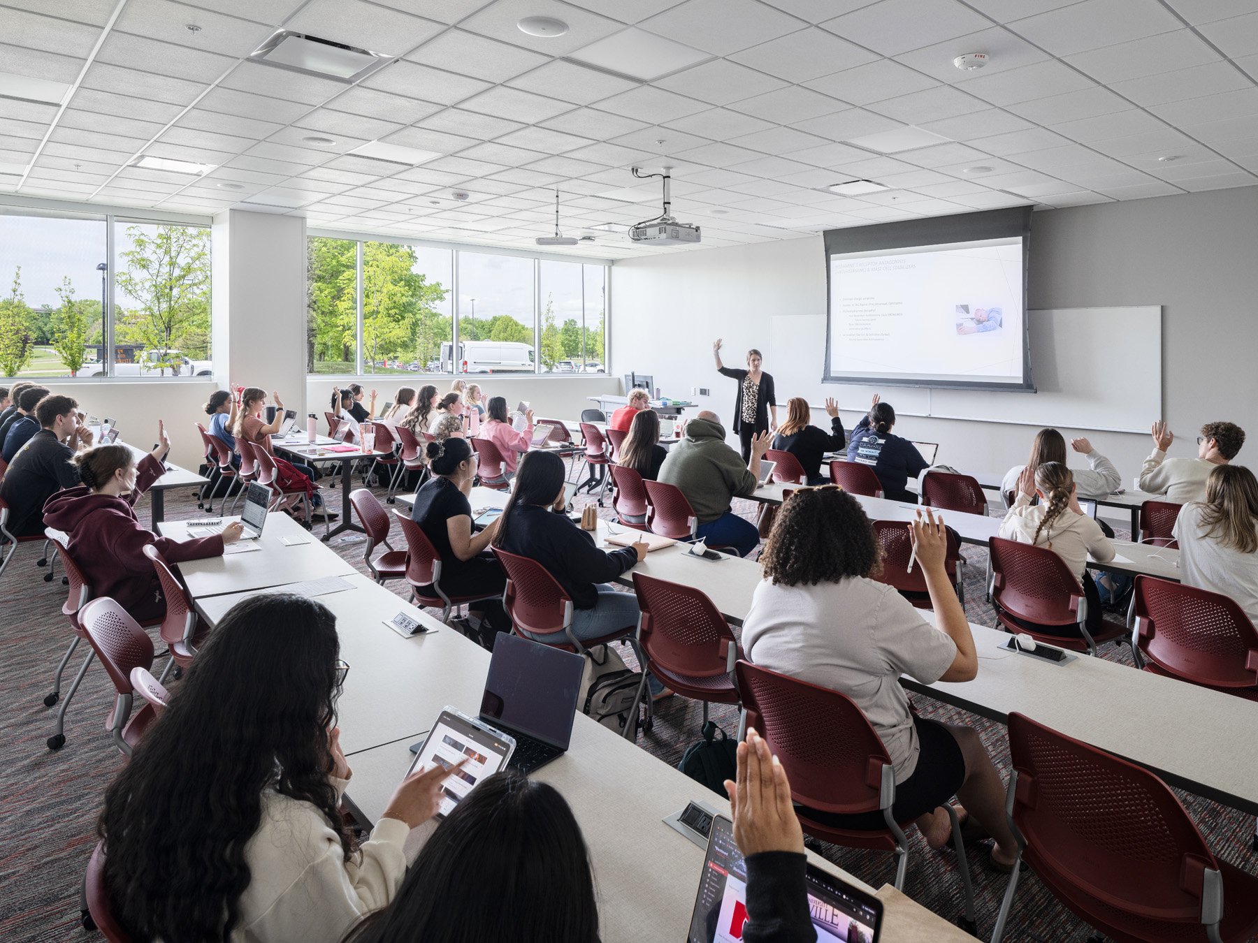 SIUE Health Sciences classroom with students at long tables and an instructor by Christner, Edwardsville Illinois - architectural photographer St. Louis