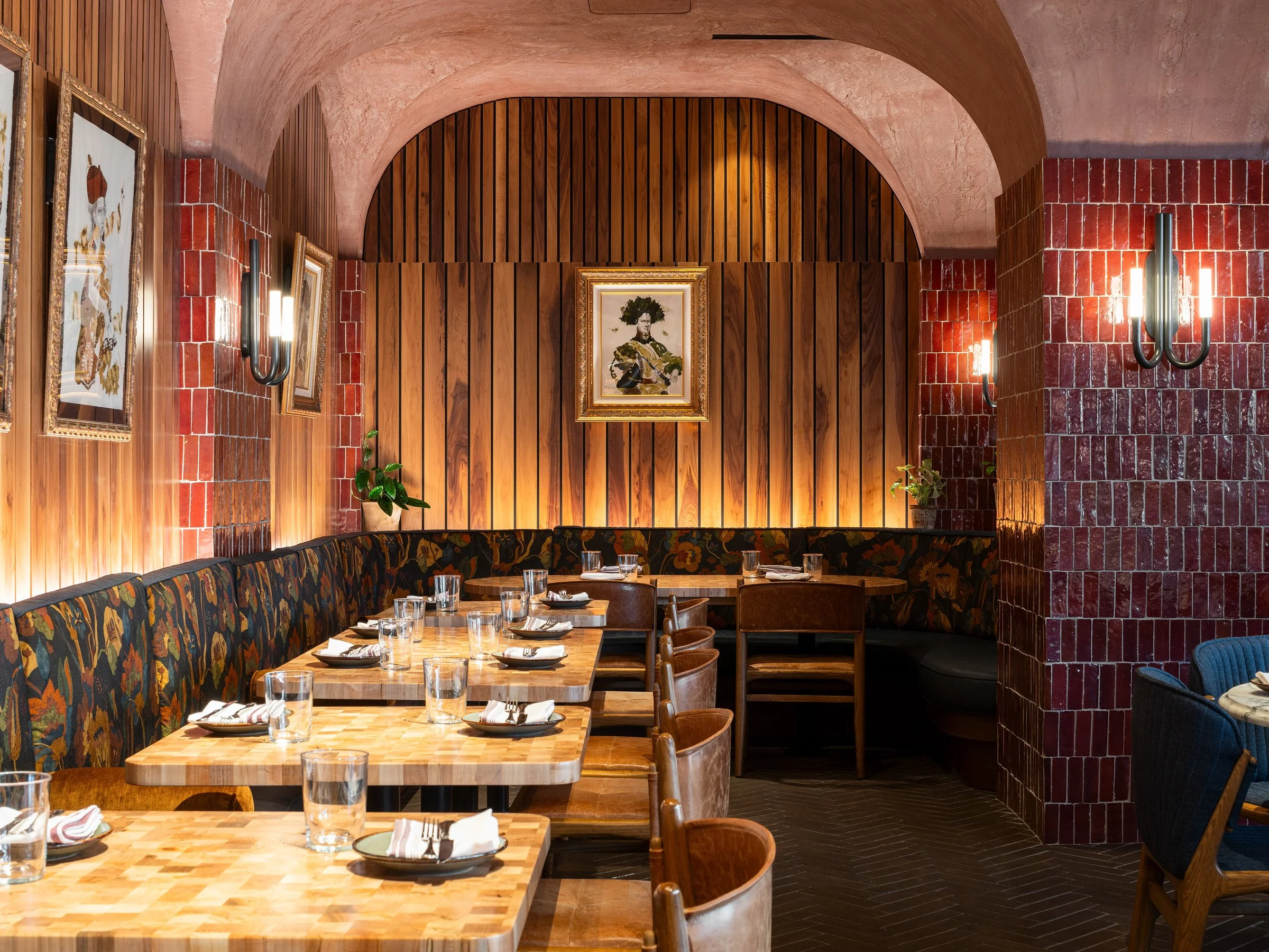 Idol Wolf restaurant interior dining nook under a vaulted pink ceiling with burgundy tile and a floral upholstered banquette, at the 21c Museum Hotel by Perfido Weiskopf Wagstaff + Goettel and Hufft - architectural photographer St. Louis Missouri