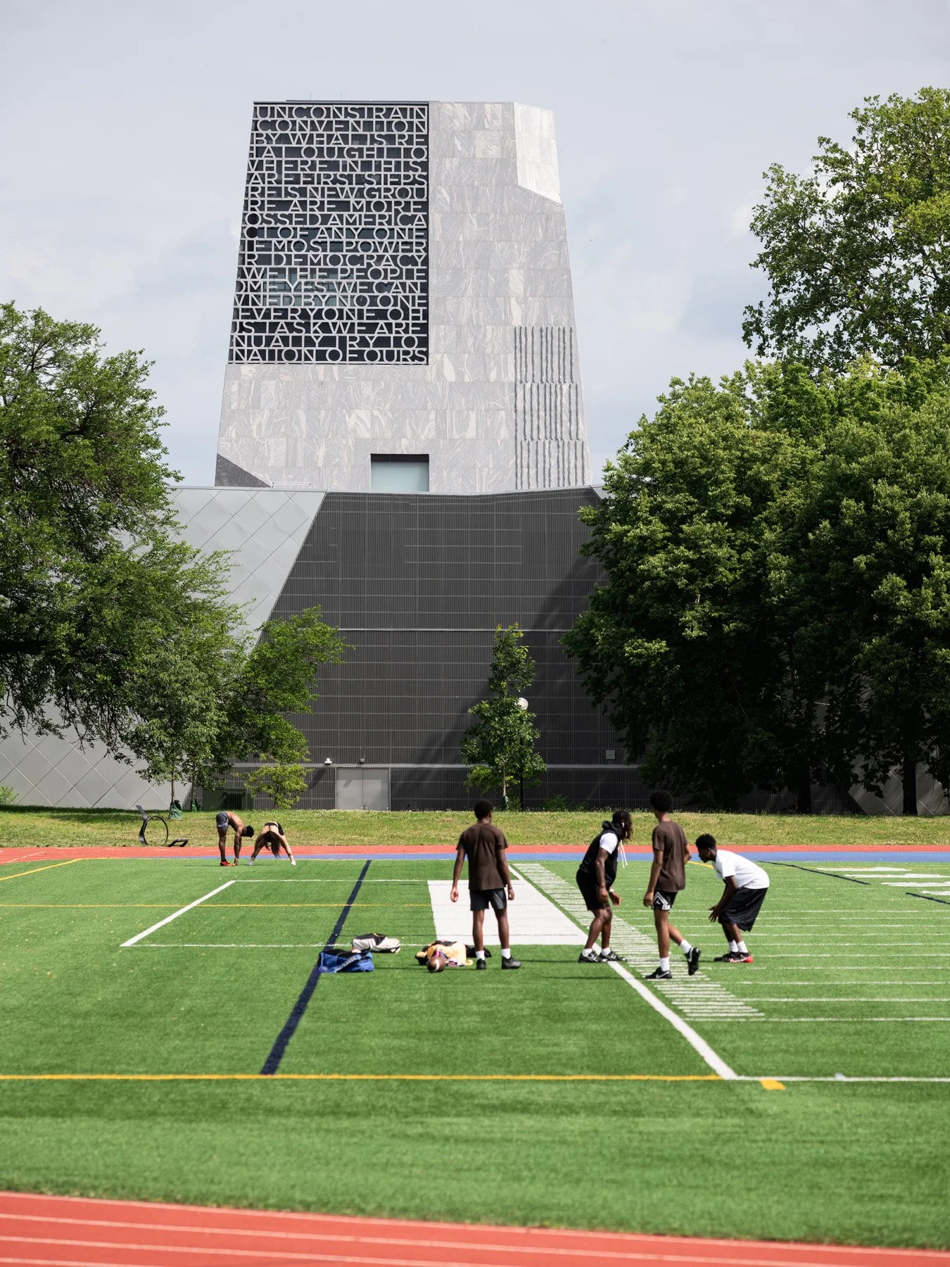 Obama Presidential Center Home Court and tower beyond an athletic field, by Moody Nolan - architectural photographer Chicago Illinois