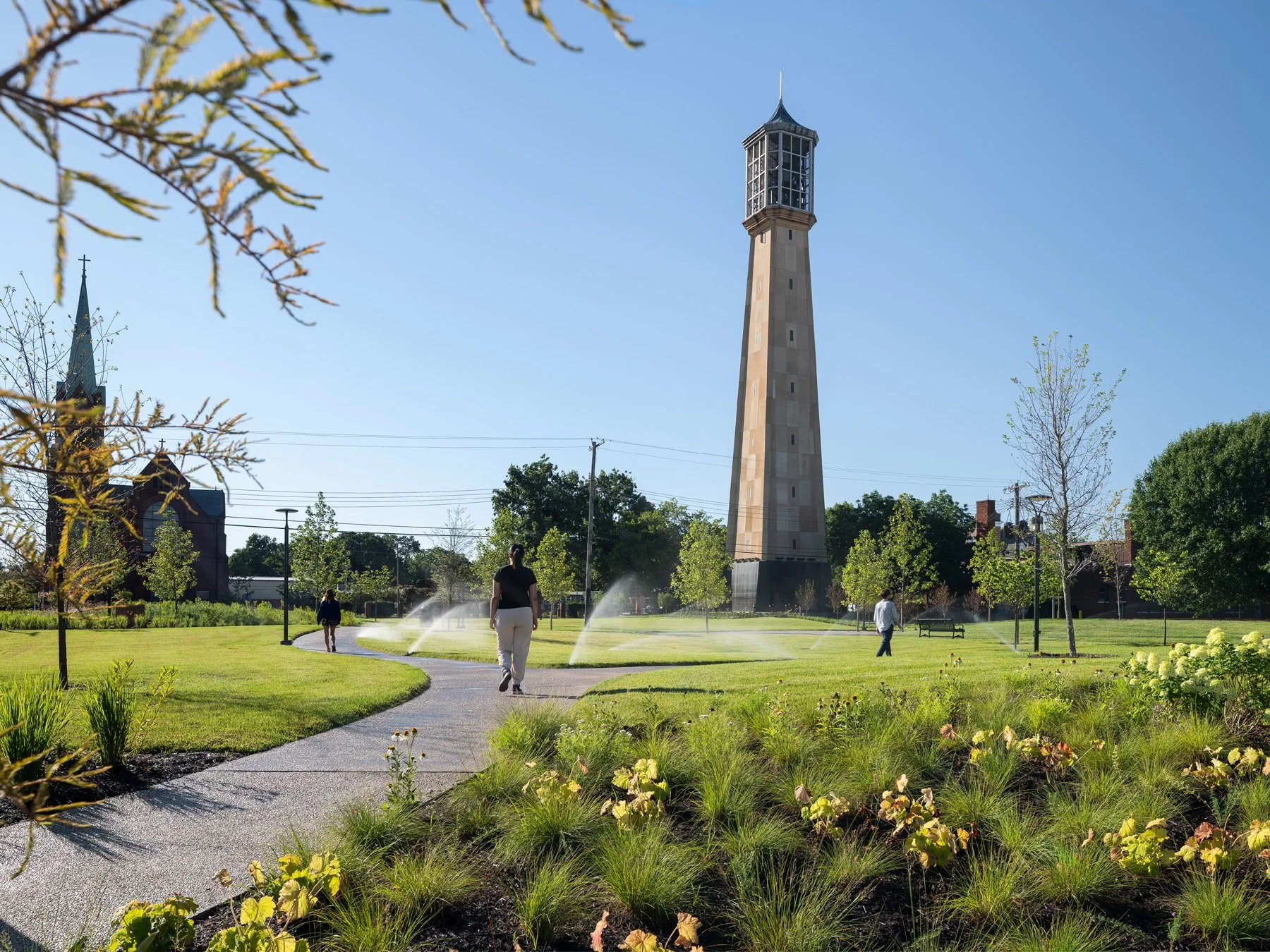 Carillon Park tower and lawn with sprinklers running at golden hour, landscape by Arbolope Studio - architectural photographer Centralia Illinois