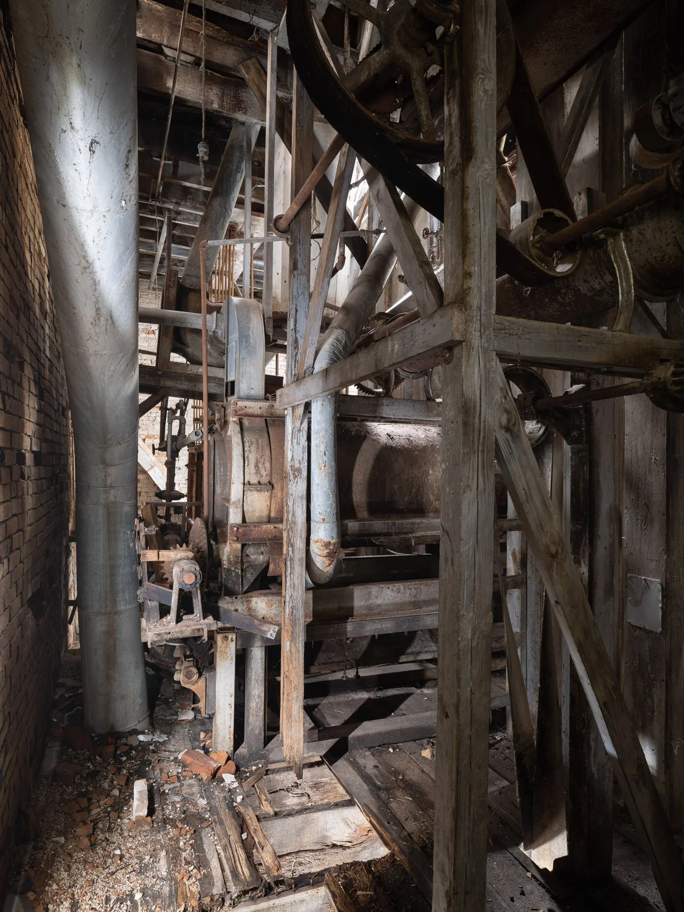 Millstadt Mill line-shaft transmission with pulleys, belts, and gearing threaded through timber framing - architectural photographer St. Louis Missouri
