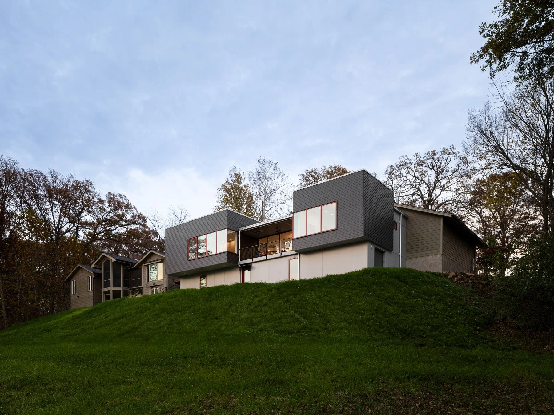 Monty Residence exterior three quarter view at dusk from the grass berm below, by Studio Lark - architectural photographer St. Louis Missouri
