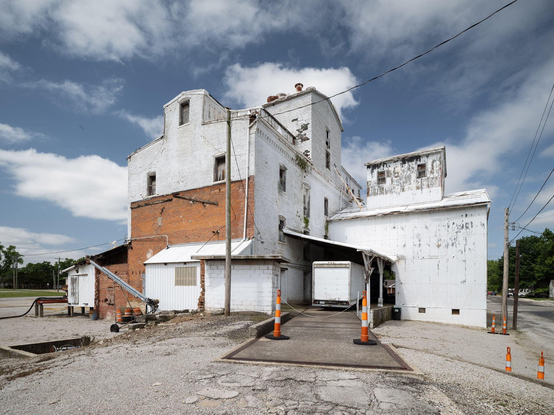 Millstadt Mill rear showing the brick mill block and the lighter later truck-loading bay addition - architectural photographer St. Louis Missouri