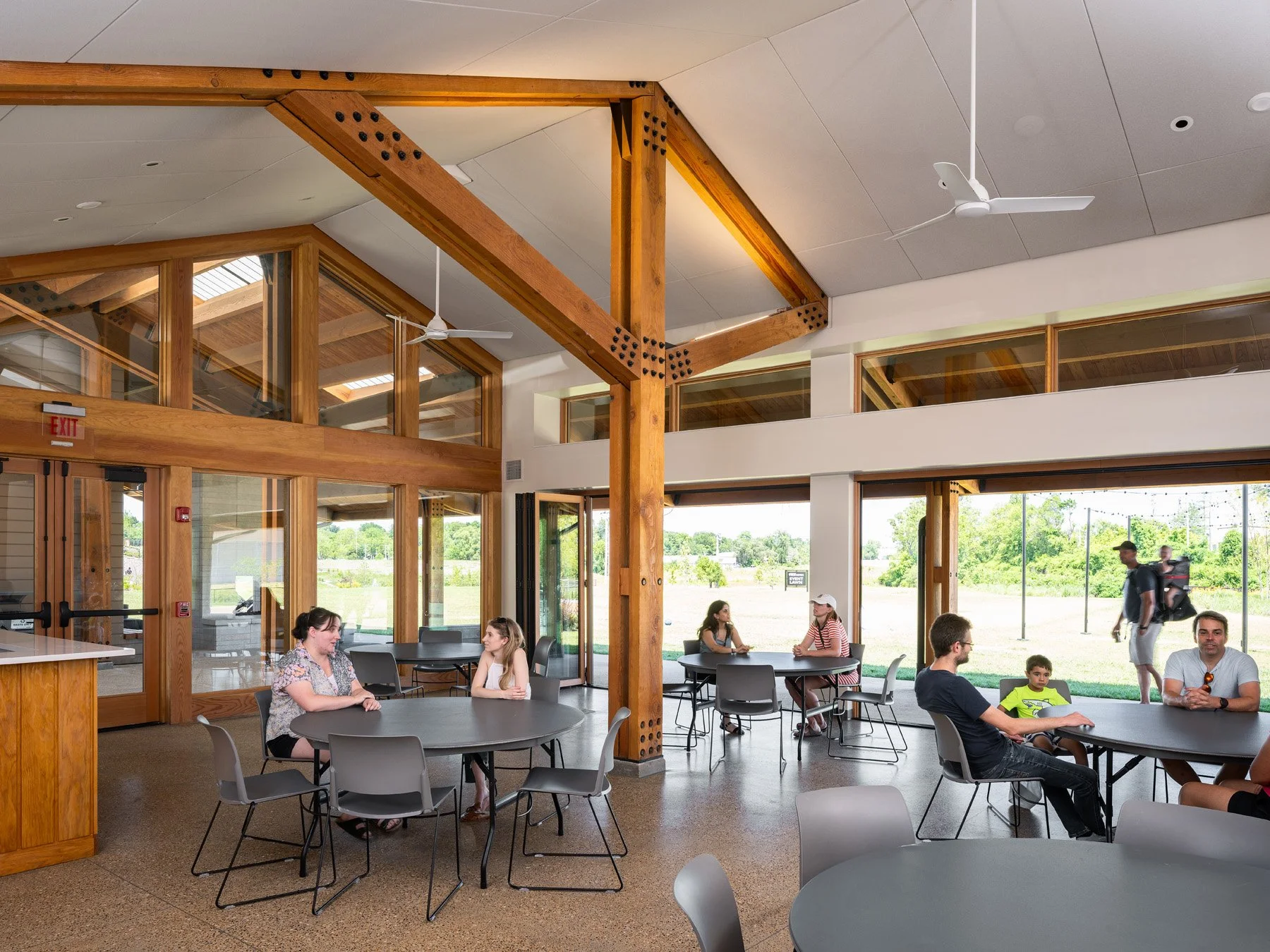 Brentwood Park Event Pavilion event hall interior with exposed timber bents and operable glass walls, by Christner - architectural photographer St. Louis Missouri