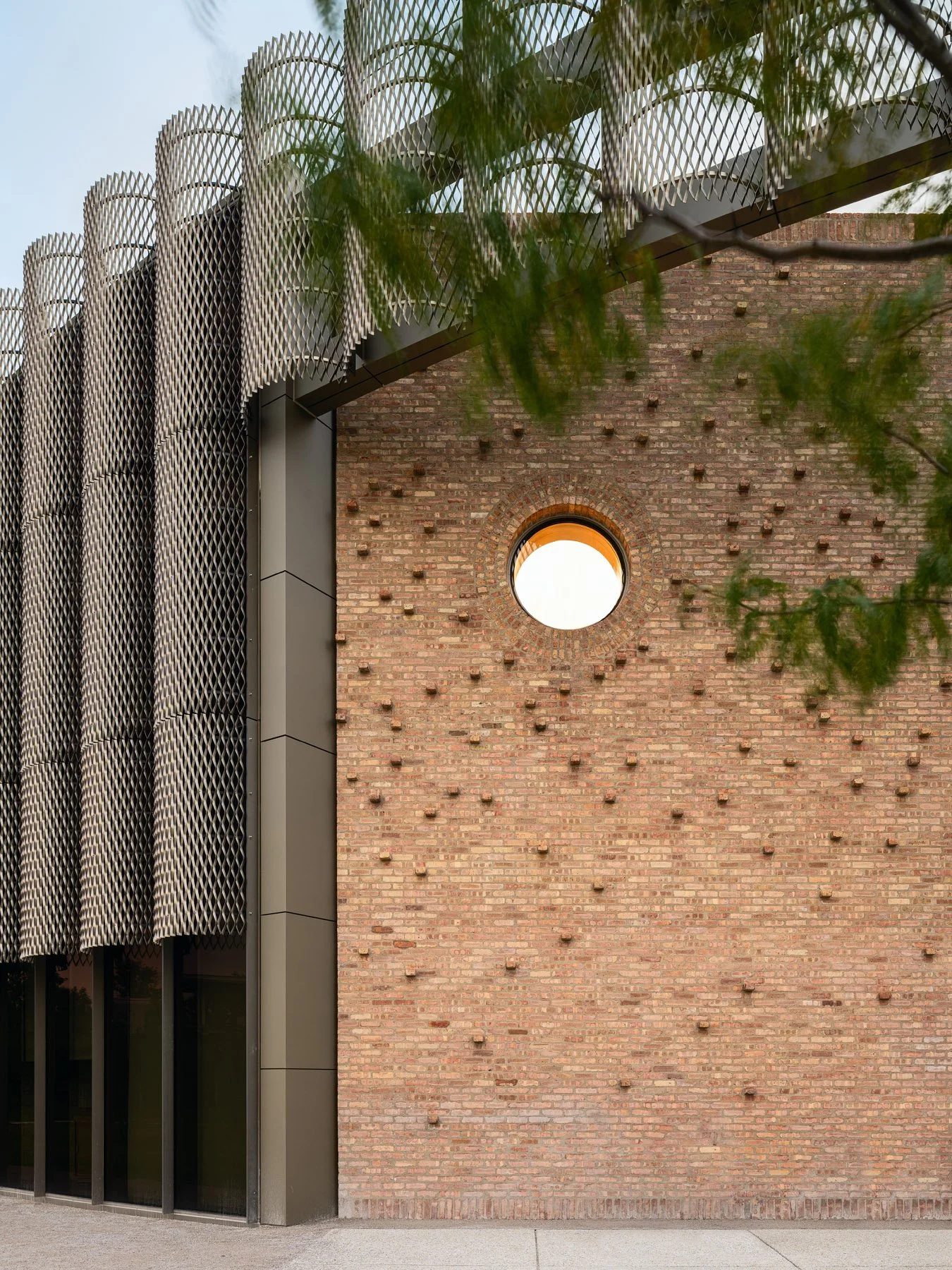 Chicago Park District HQ salvaged brick wall with round oculus window and projecting brick relief, by John Ronan Architects - architectural photographer Chicago Illinois