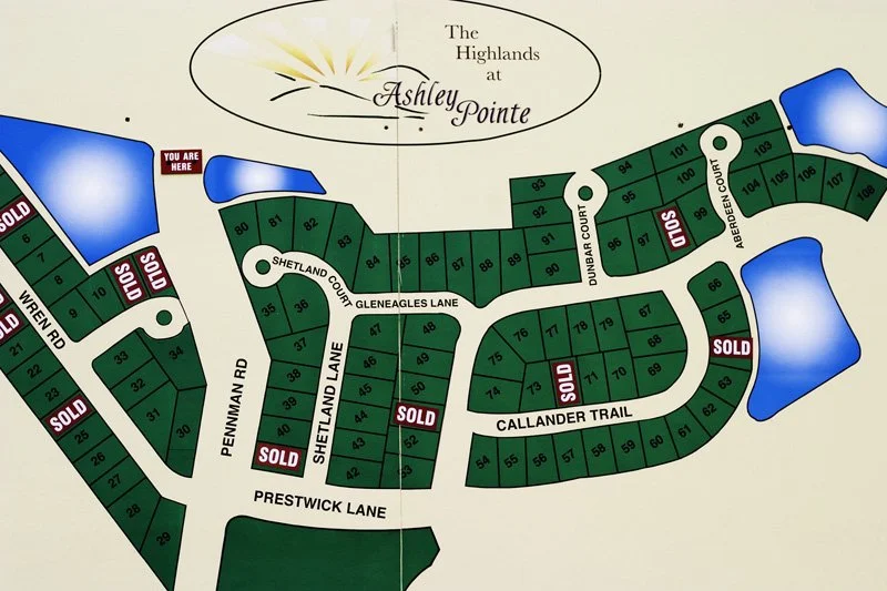 Printed subdivision plat sales map for The Highlands at Ashley Pointe showing numbered lot parcels with multiple red and white SOLD stickers, cul-de-sacs, and street names, Chicago Illinois exurbs