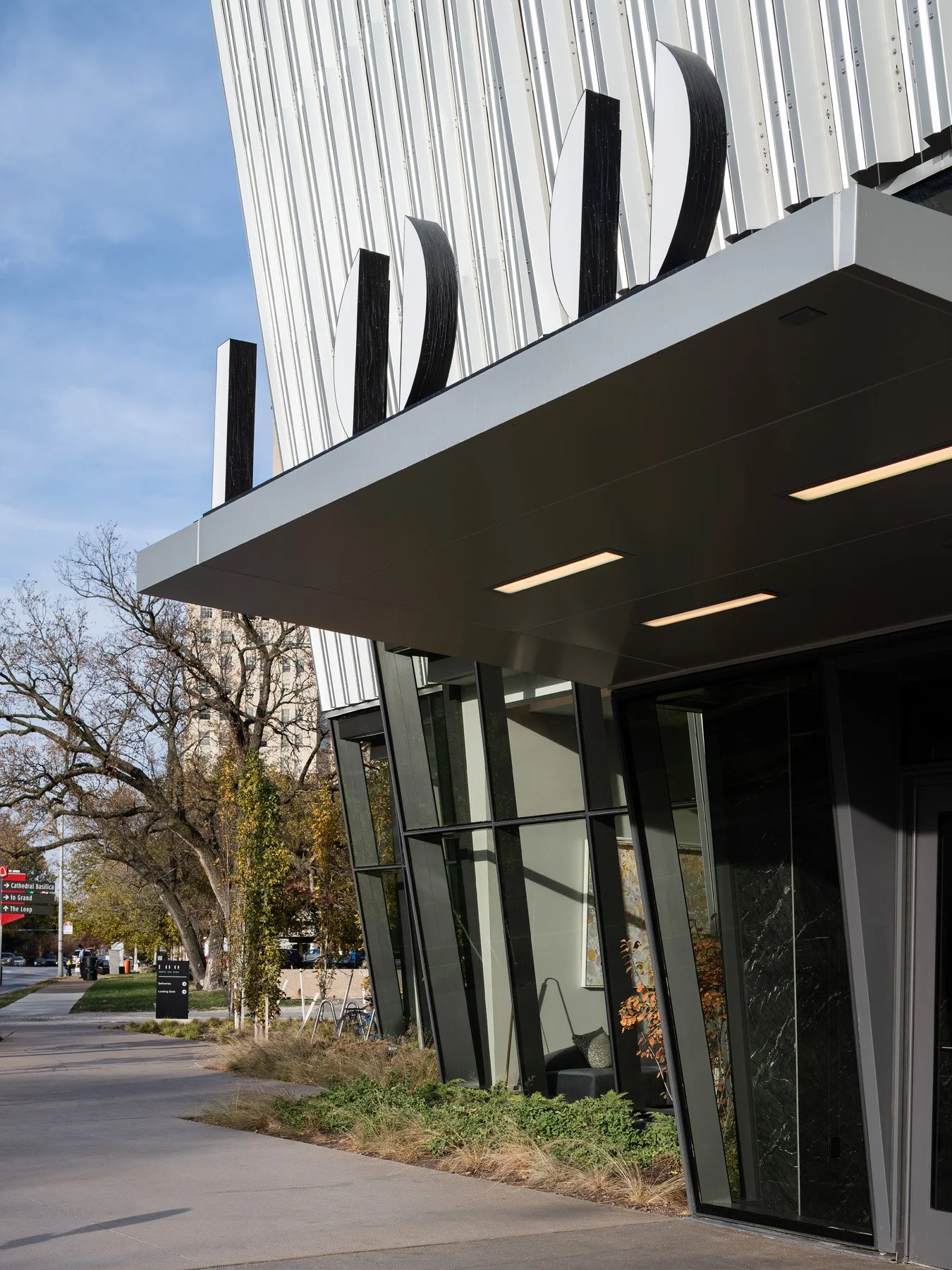 One Hundred Above the Park entry canopy with building signage and angled glazing, by Studio Gang - architectural photographer St. Louis Missouri