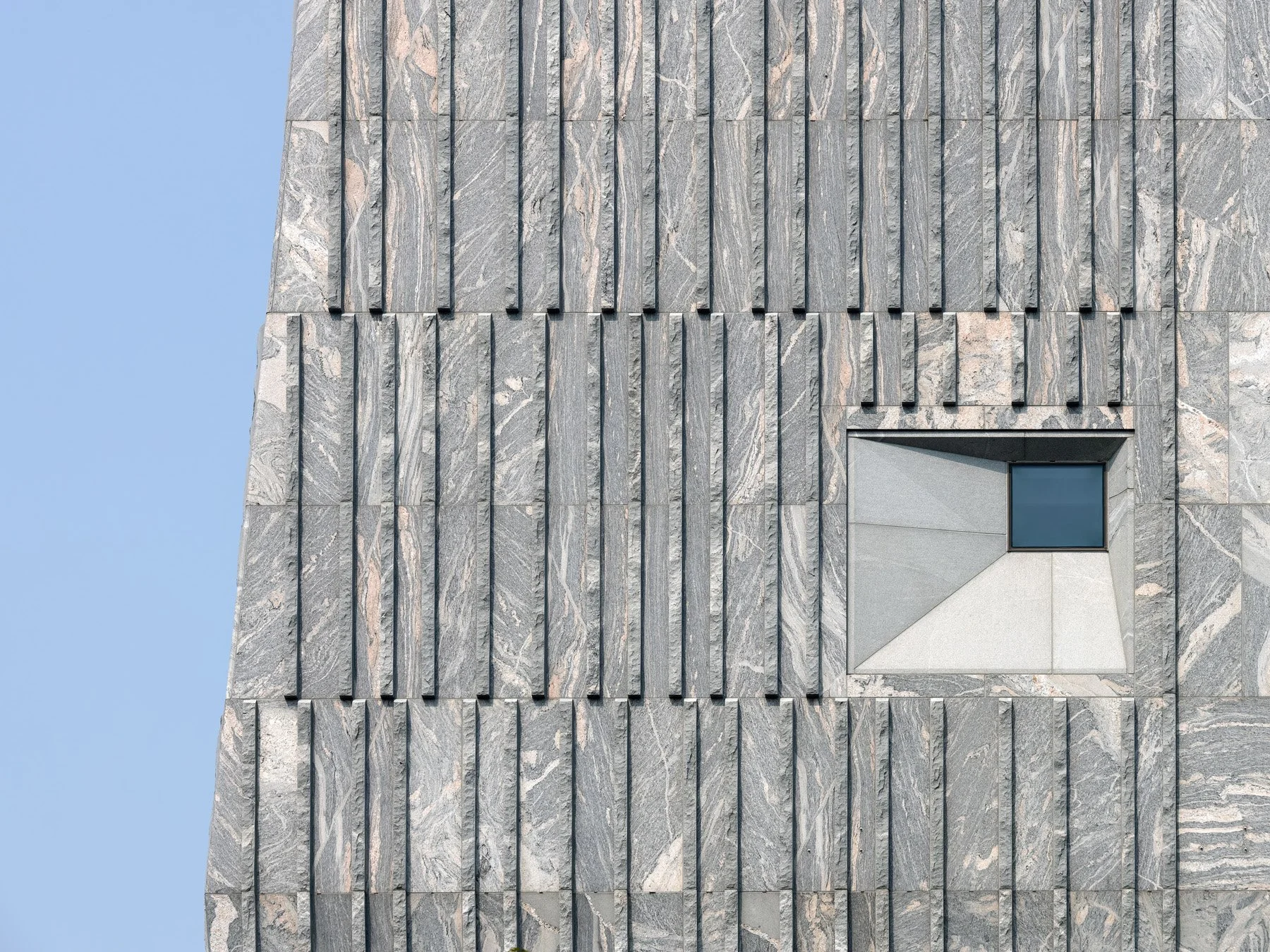 Obama Presidential Center fluted granite facade with canted window, by Tod Williams Billie Tsien - architectural photographer Chicago Illinois