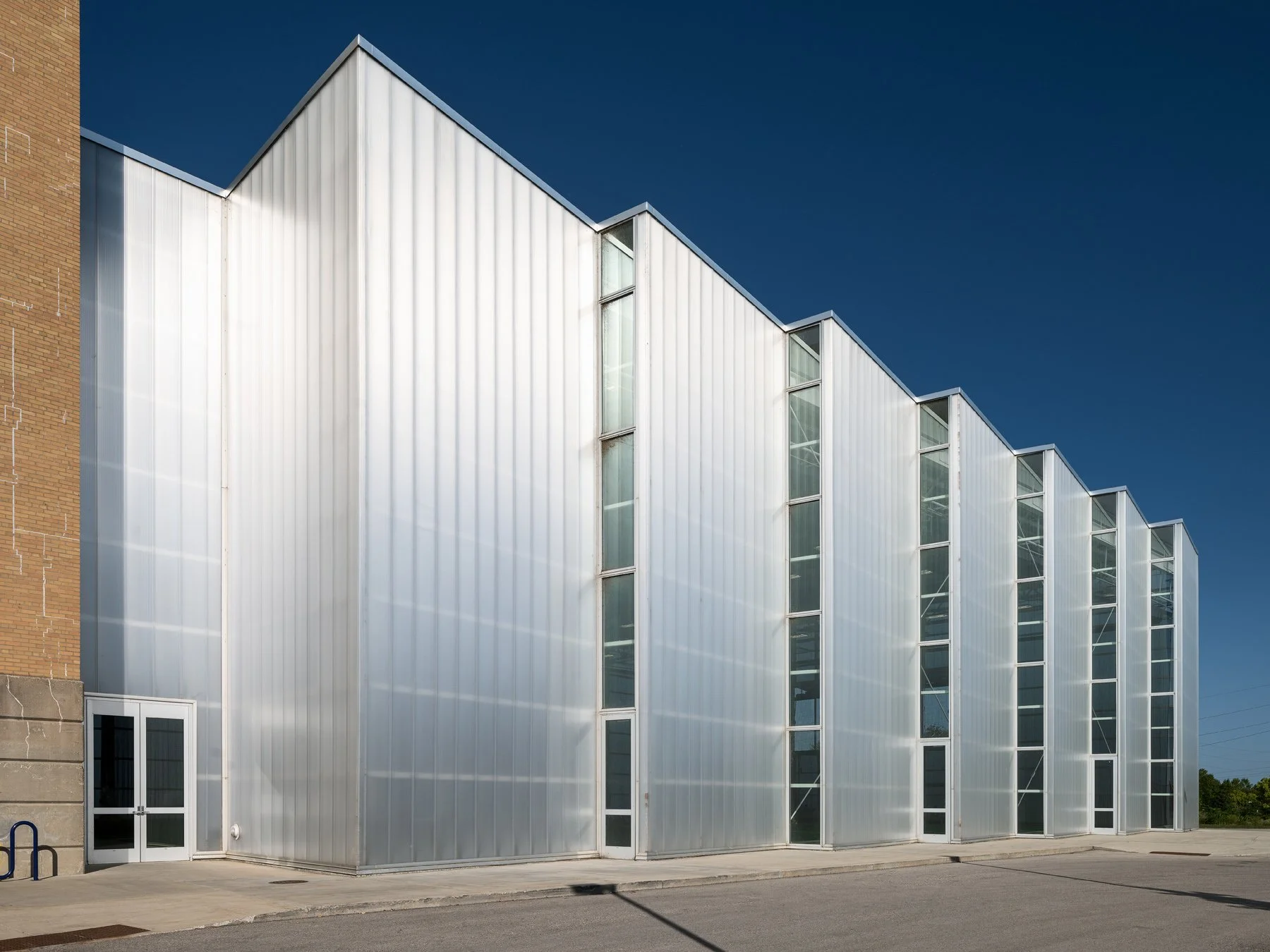 Beloit College Powerhouse translucent field house with a stepped sawtooth roofline, by Studio Gang - architectural photographer Beloit Wisconsin