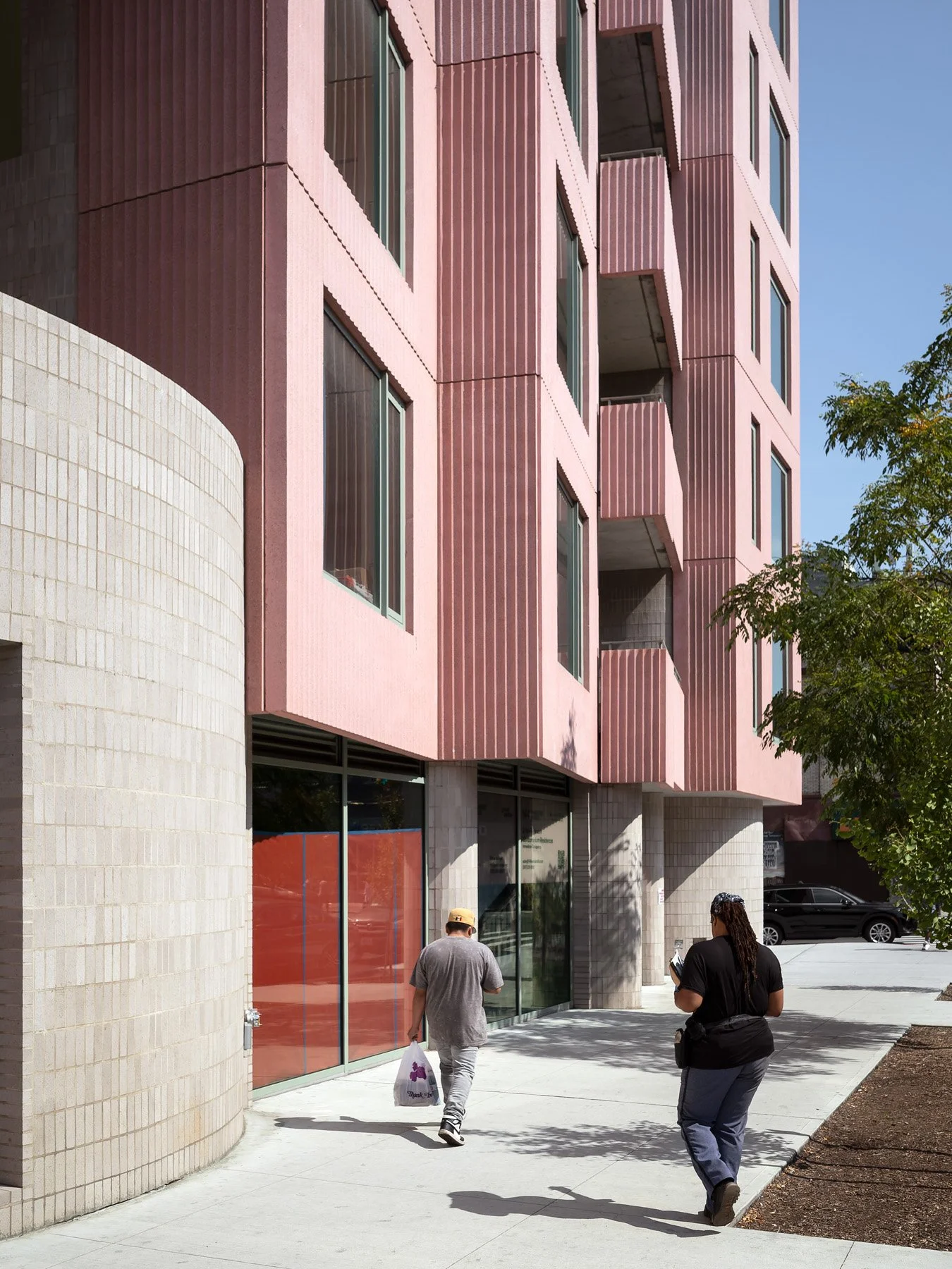 144 Vanderbilt curved white-tiled base and storefront glazing with pedestrians on the sidewalk, by SO-IL, - architectural photographer New York