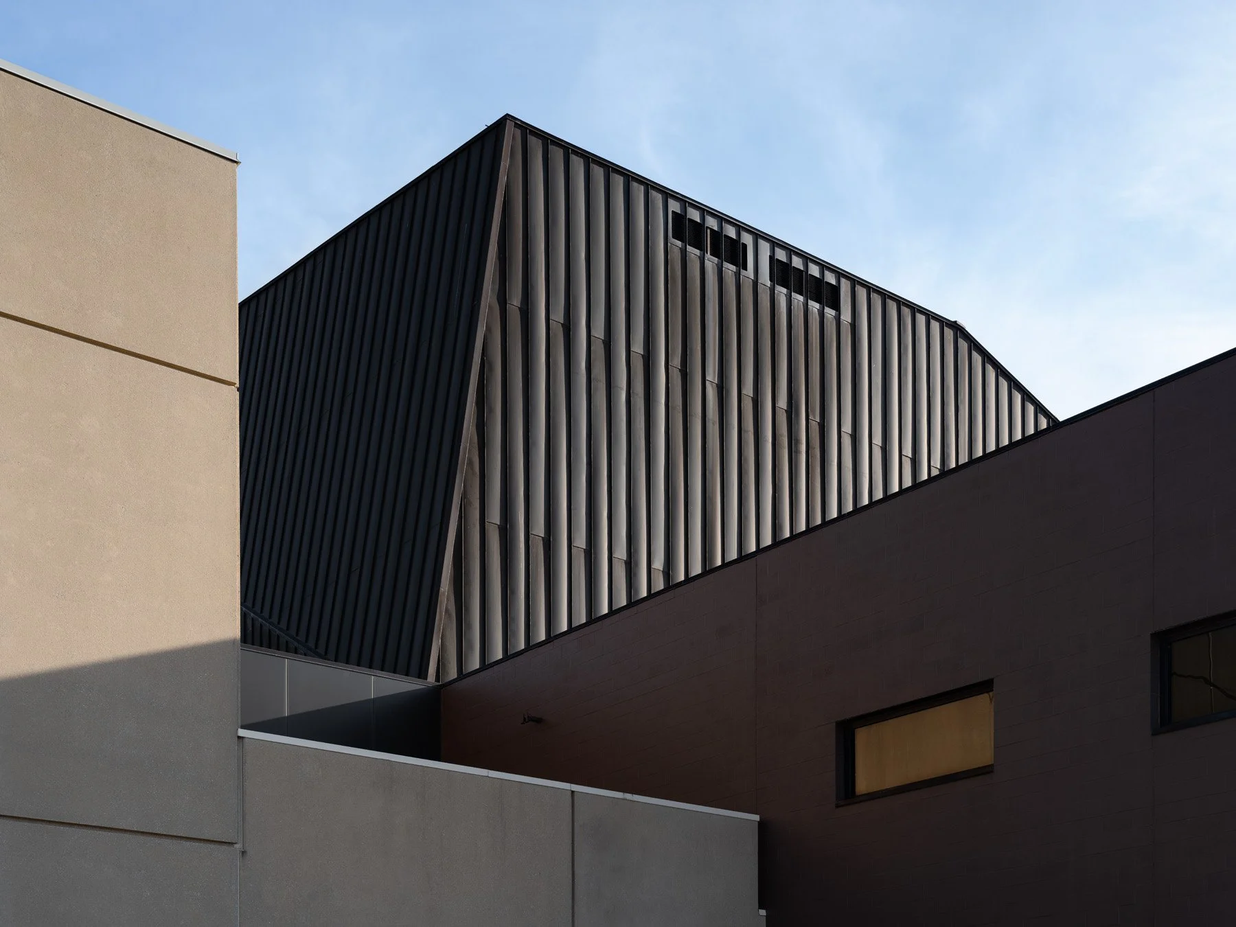 Doudna Fine Arts Center exterior copper-clad fly tower rising above stucco and masonry volumes by Antoine Predock, Charleston Illinois - architectural photographer