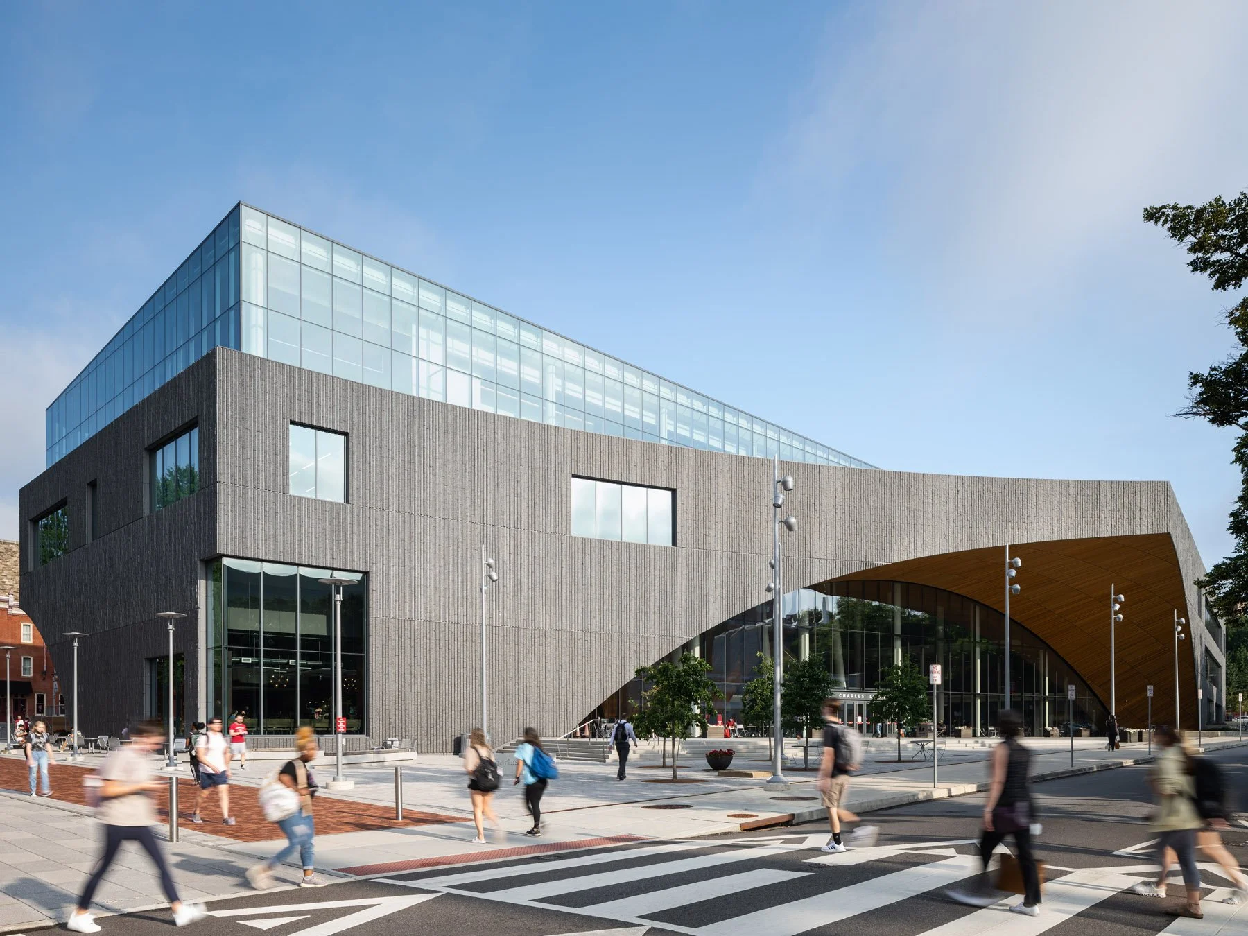 Charles Library exterior, students crossing below the arched soffit, by Snøhetta, Philadelphia - architectural photographer Philadelphia