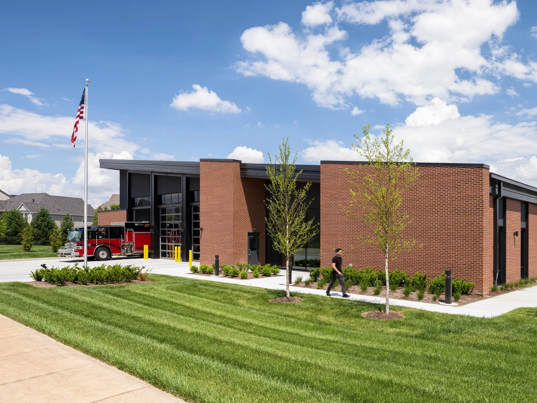 St. Charles fire station brick corner with flag and an engine, by JEMA, St. Charles Missouri - architectural photographer St. Louis Missouri