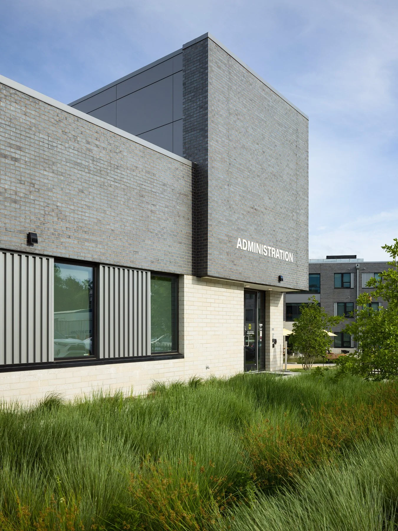 DOORWAYS administration building corner with signage, landscape by Arbolope Studio - architectural photographer St. Louis Missouri