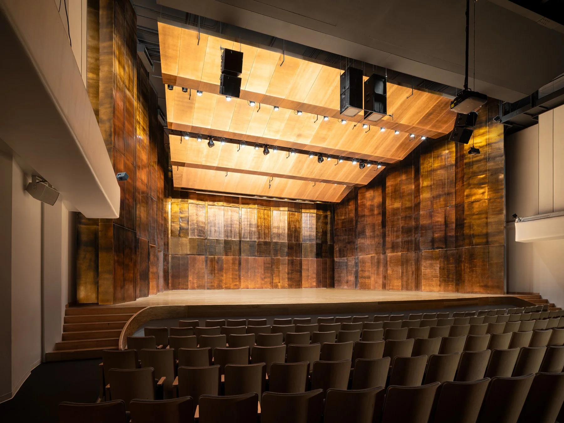 Doudna Fine Arts Center recital hall interior with copper wall panels and lit wood stage by Antoine Predock, Charleston Illinois - architectural photographer