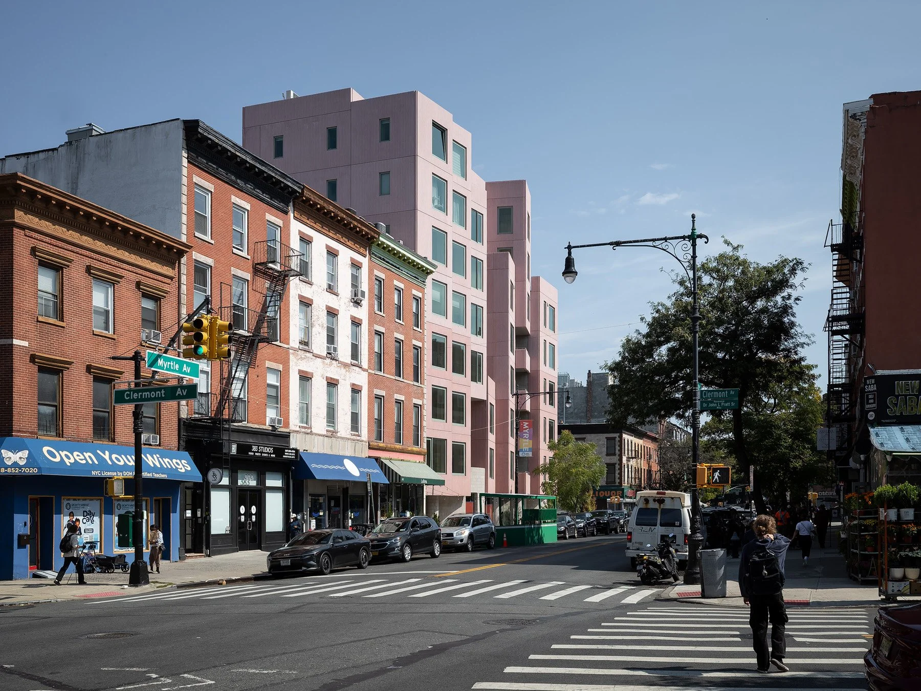 144 Vanderbilt rising in pink above brick rowhouses along Myrtle Avenue, by SO-IL, Brooklyn - architectural photographer New York