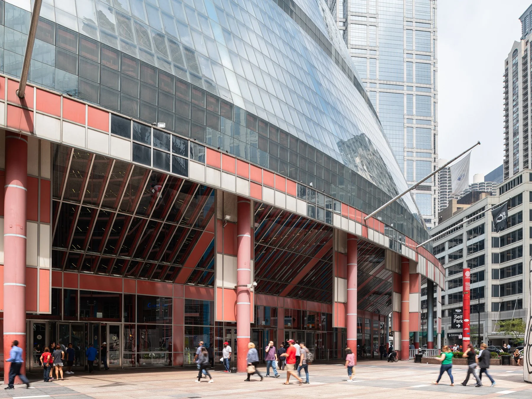 James R. Thompson Center covered arcade on red columns, Marina City beyond, Chicago - salmon columns postmodern arcade