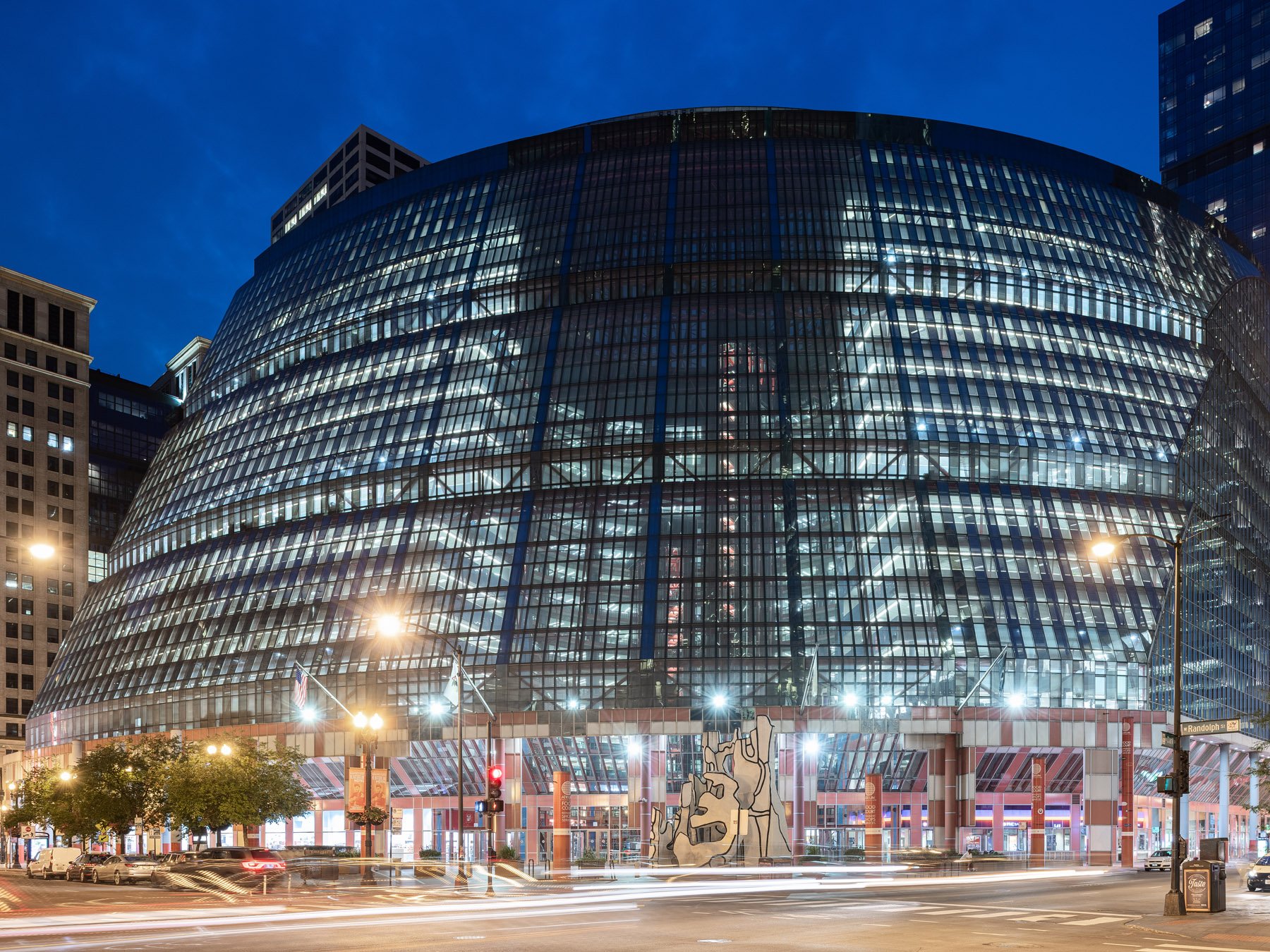 James R. Thompson Center at night, the glass dome glowing over Dubuffet's Monument with Standing Beast, Chicago - blue hour exterior