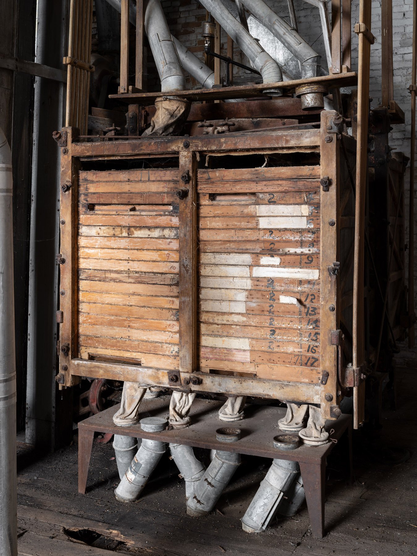 Millstadt Mill wood-cased gravity sifter, its sieve frames numbered by hand from two through seventeen - architectural photographer St. Louis Missouri
