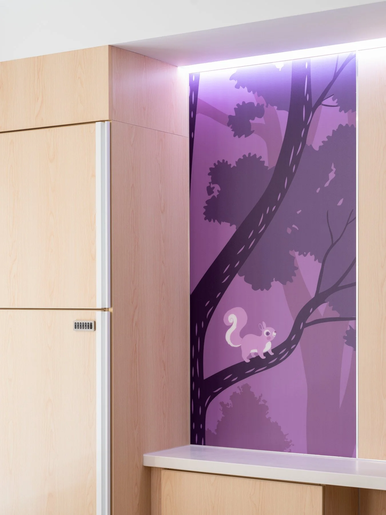 St. Louis Children’s Hospital backlit purple squirrel mural beside wood casework, by CannonDesign - architectural photographer St. Louis Missouri