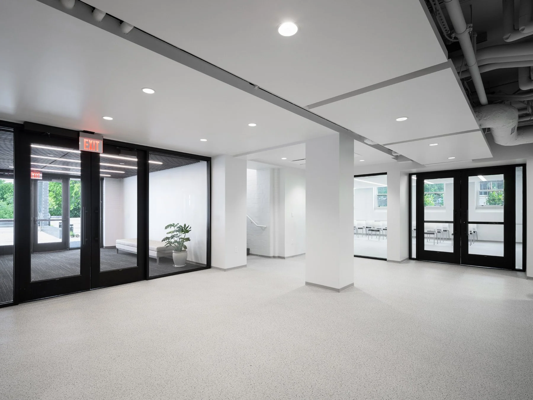 Des Peres City Hall interior lobby with terrazzo floor and black-framed glass partitions by Patterhn Ives, Des Peres Missouri - architectural photographer St. Louis