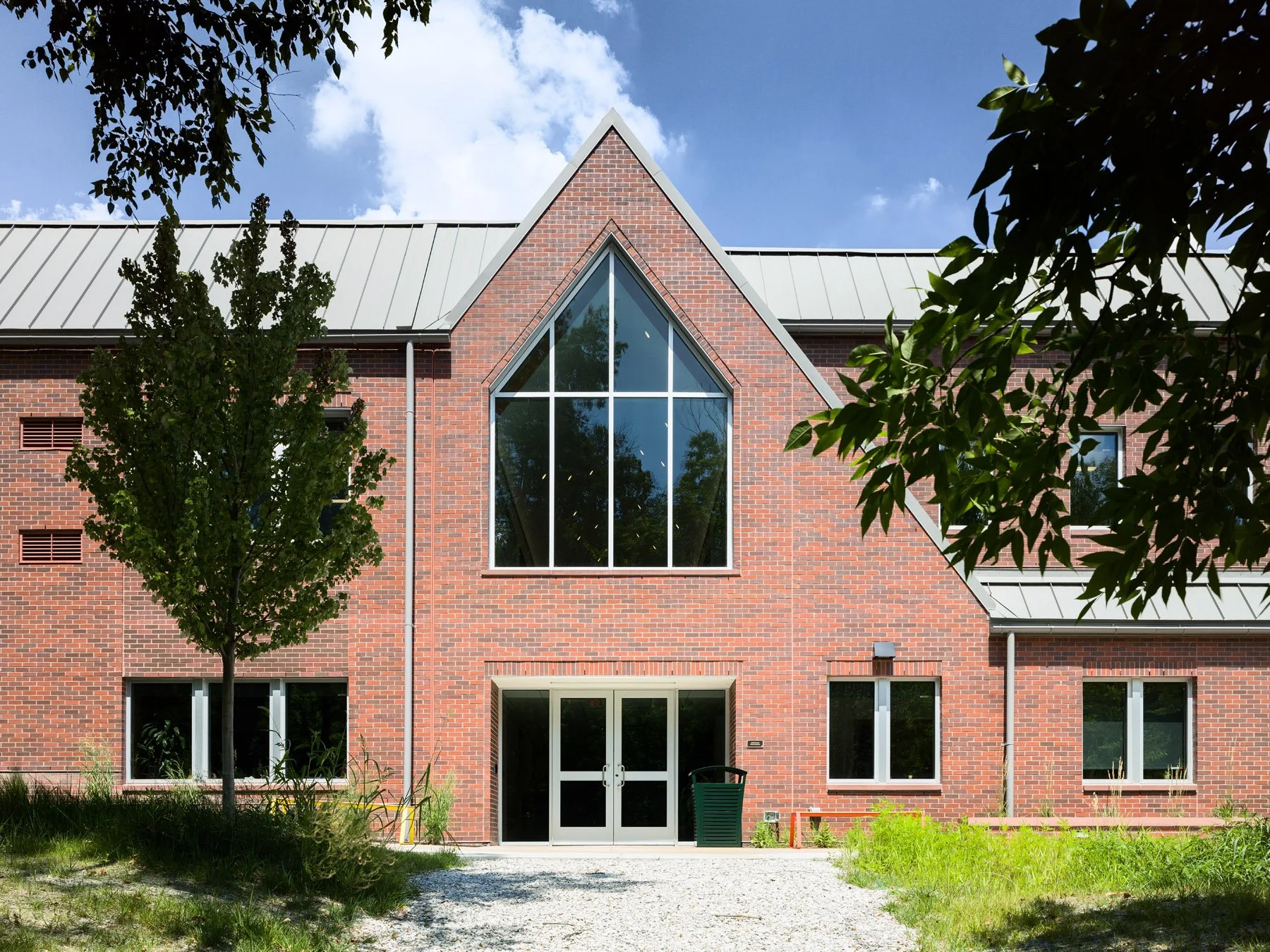 Broughton STEAM Center rear brick gable with a tall peaked triangular window, by Christner - architectural photographer St. Louis Missouri