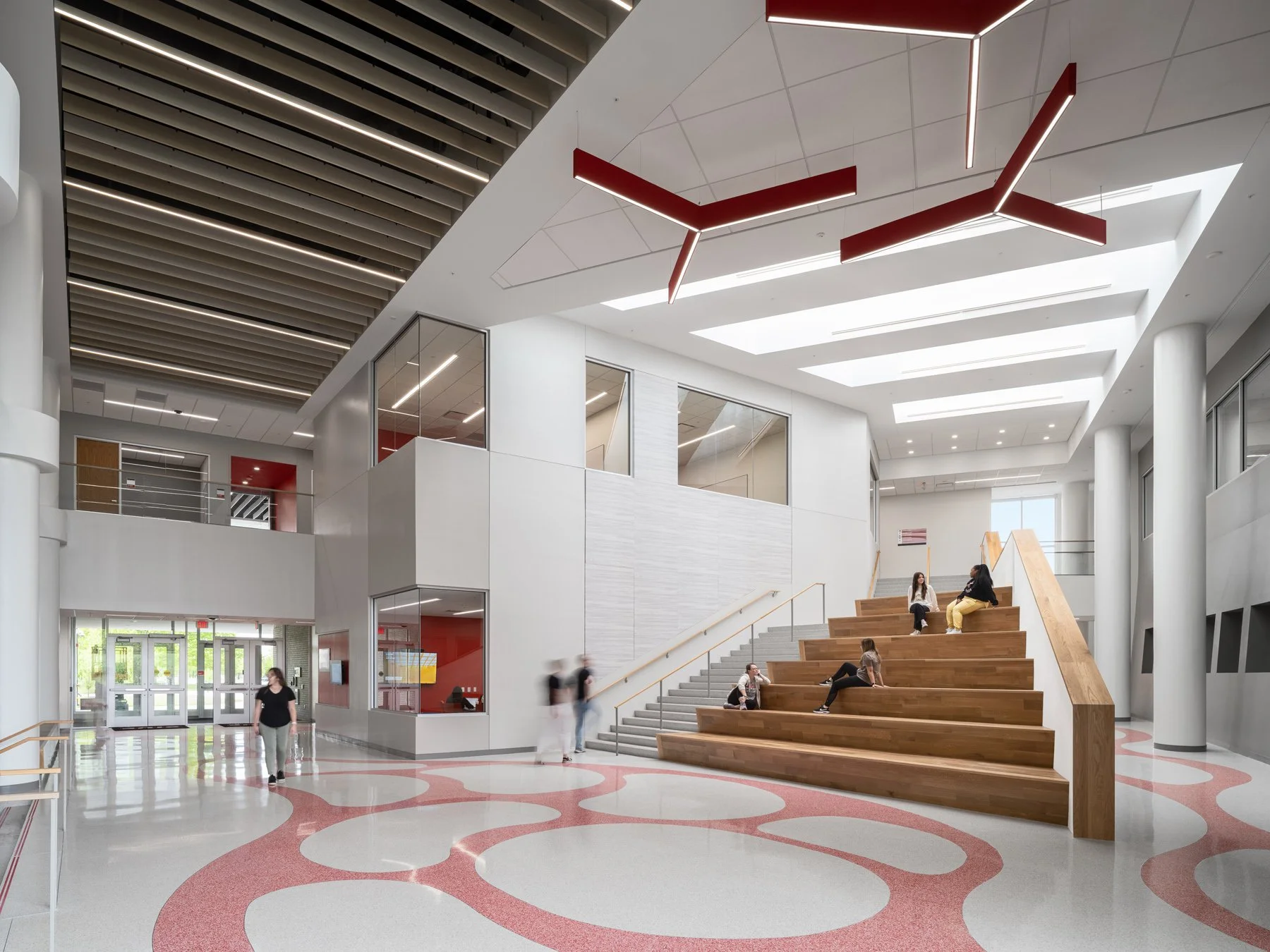 SIUE Health Sciences atrium with red vascular terrazzo floor and wood bleacher stair by Christner, Edwardsville Illinois - architectural photographer St. Louis