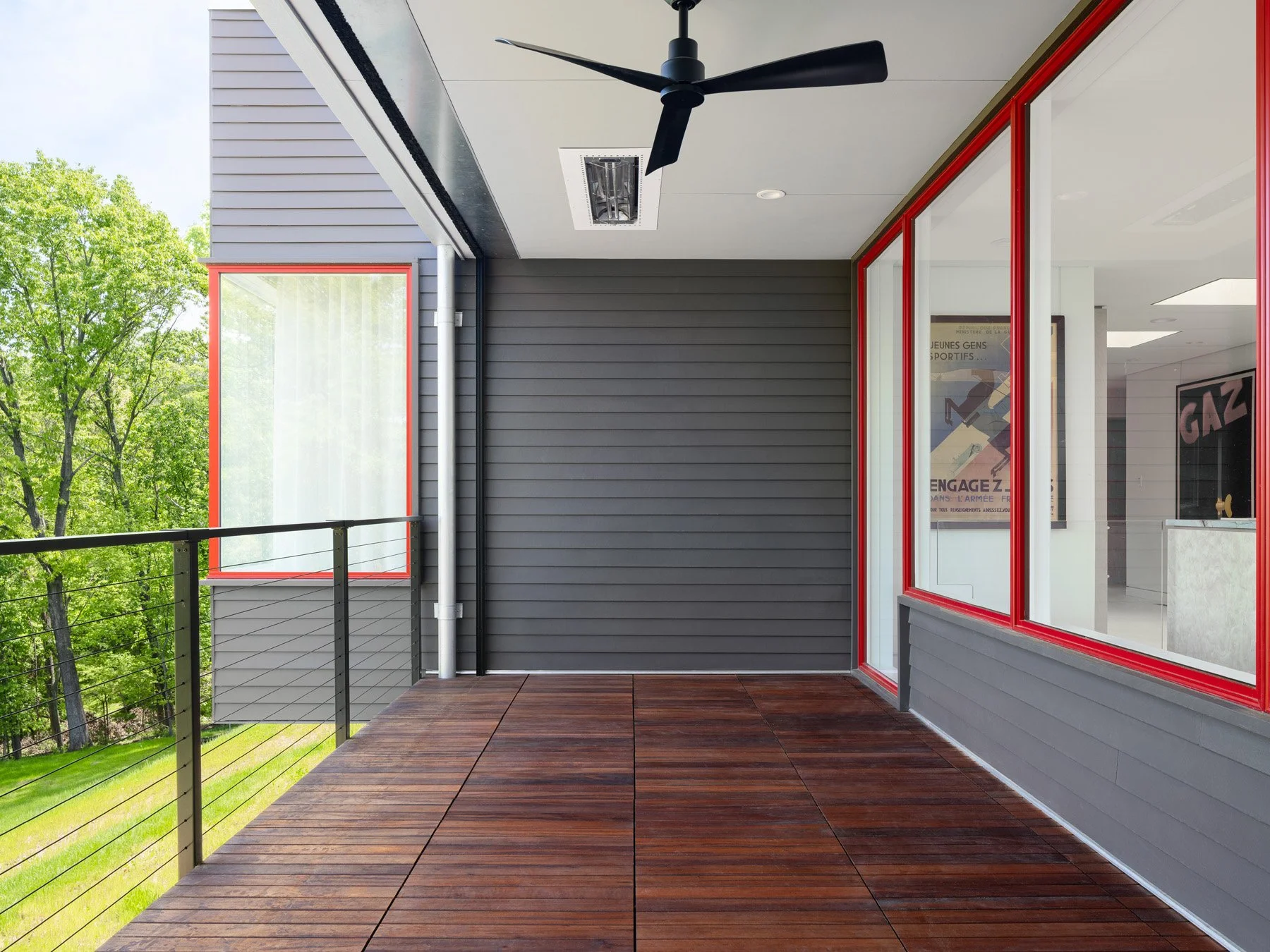 Monty Residence exterior covered deck with wood decking and red window frames, by Studio Lark - architectural photographer St. Louis Missouri