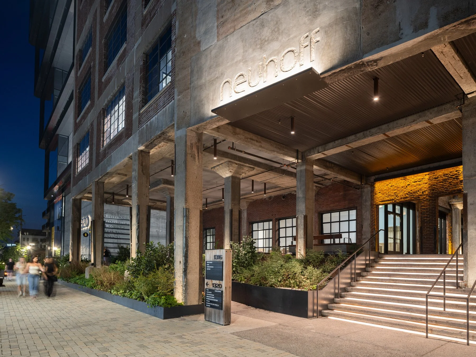 Neuhoff District entry stair under the concrete colonnade lit at night by Smith Gee Studio - architectural photographer Nashville Tennessee