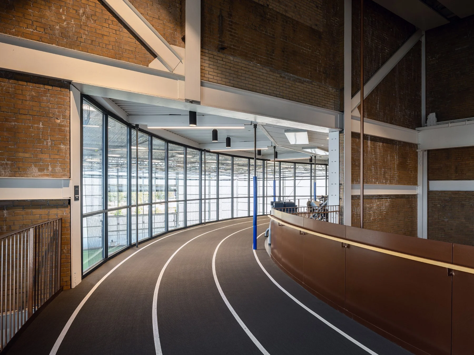 Beloit College Powerhouse suspended running track curving past original brick walls, by Studio Gang - architectural photographer Beloit Wisconsin