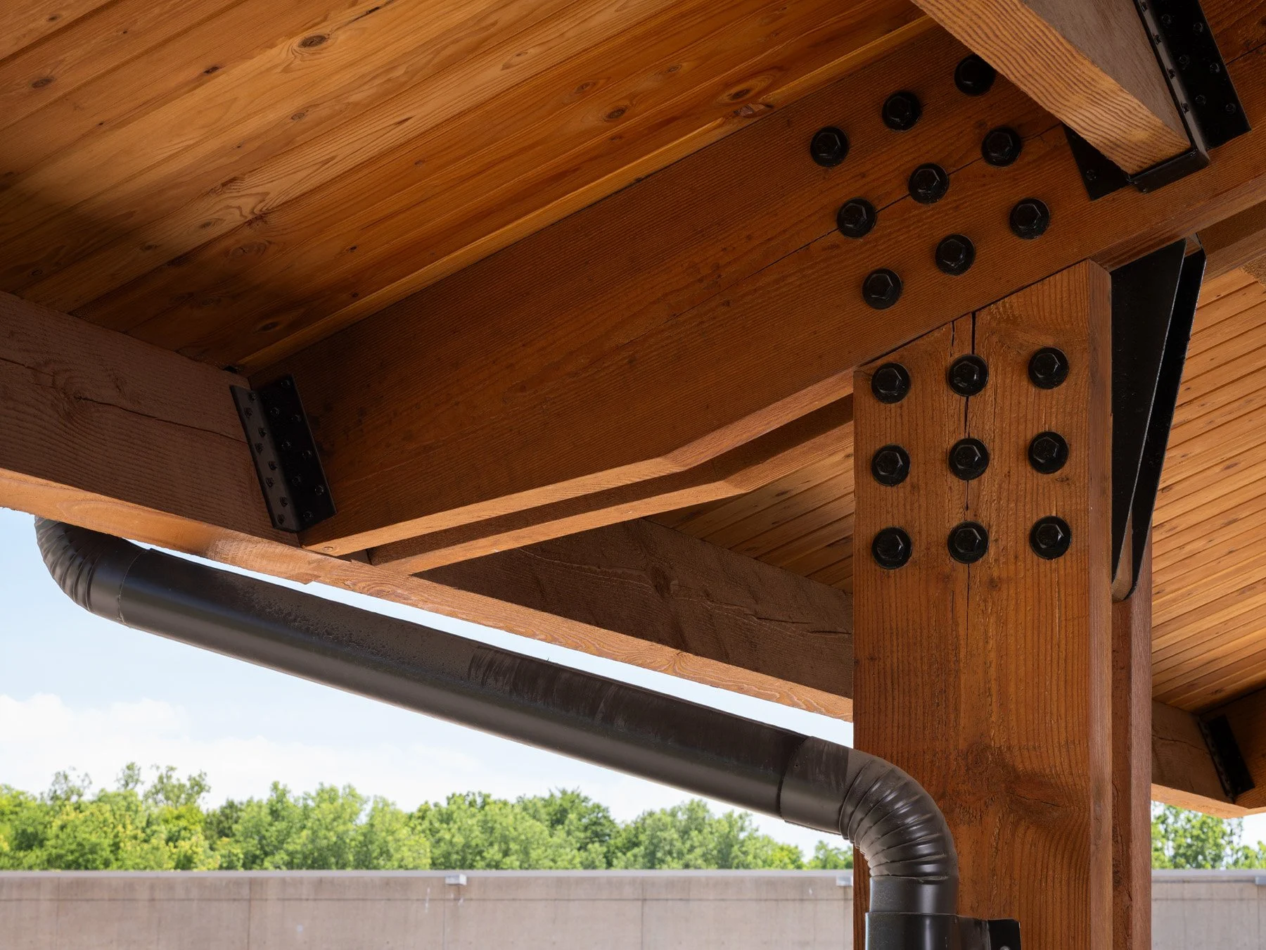 Brentwood Park Event Pavilion timber beam-column connection detail with exposed black bolts, by Christner - architectural photographer St. Louis Missouri