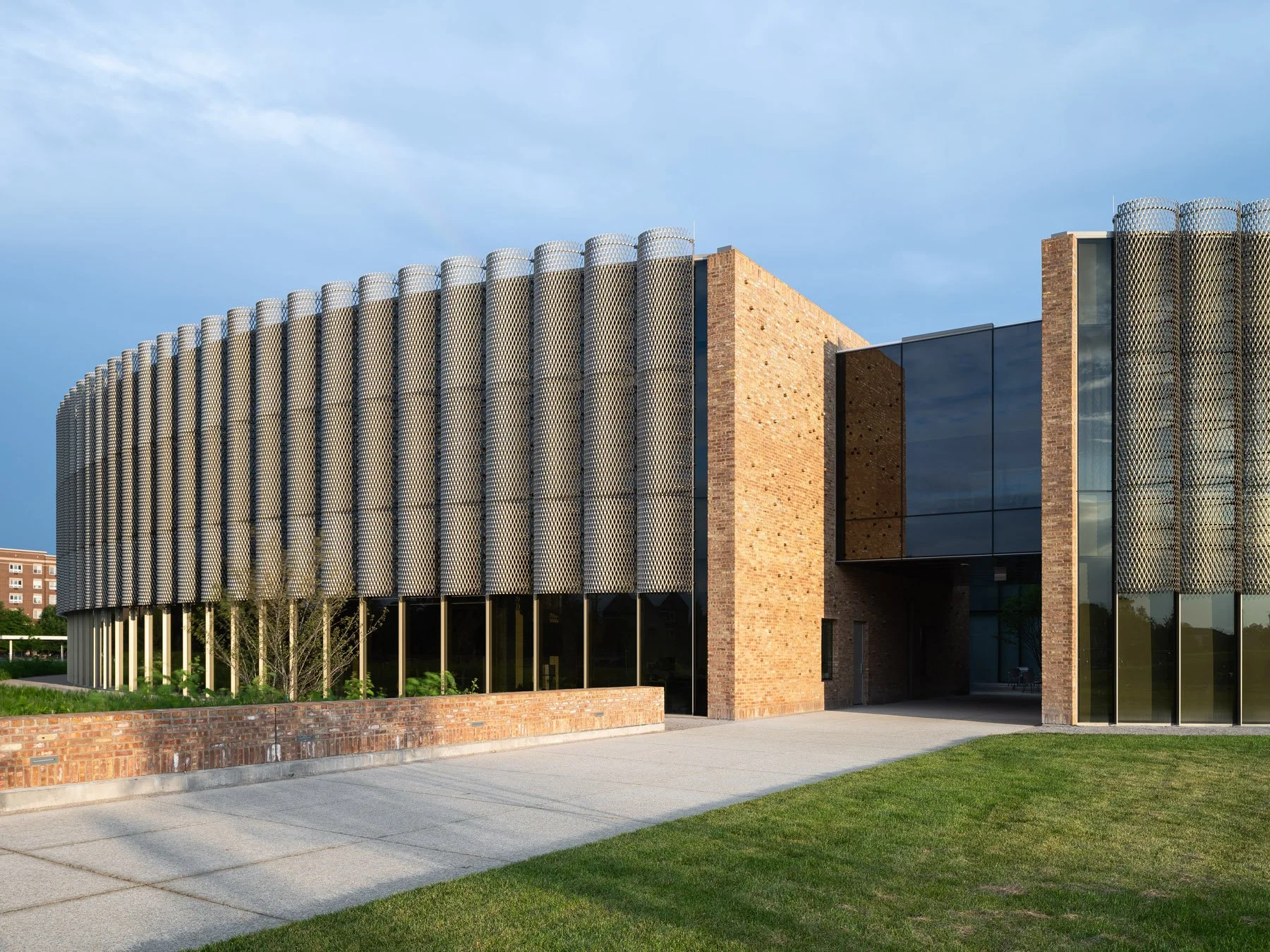 Chicago Park District HQ north entry at dusk, brick volumes flanking glass curtainwall, by John Ronan Architects - architectural photographer Chicago Illinois