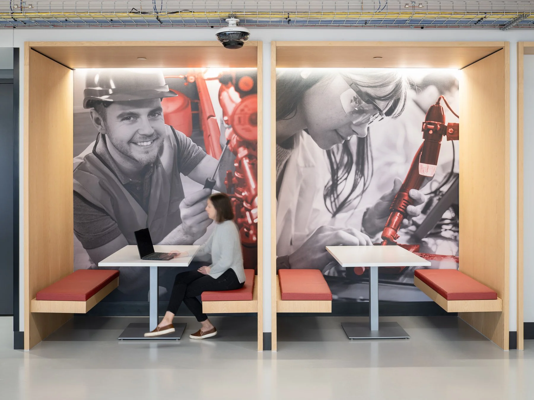 Regional Workforce Innovation Center study booths set into wood-framed banquettes with large black-and-white workforce trade murals, St. Charles Community College, Wentzville, Missouri, by JEMA - architectural photographer St. Louis Missouri