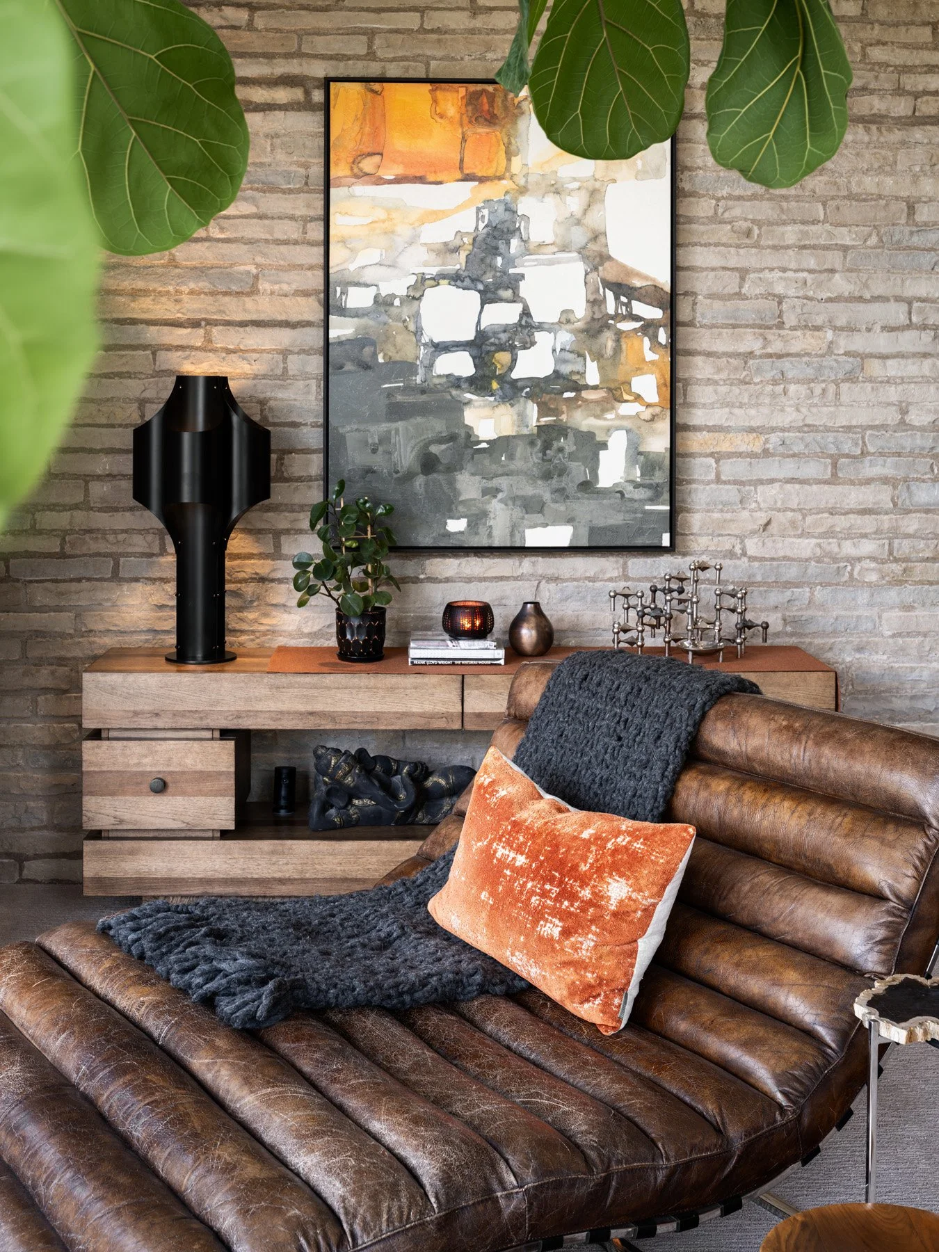 Garrison House seating detail, leather chaise and credenza against a stone wall, Sleepy Hollow Illinois - architectural photographer Chicago