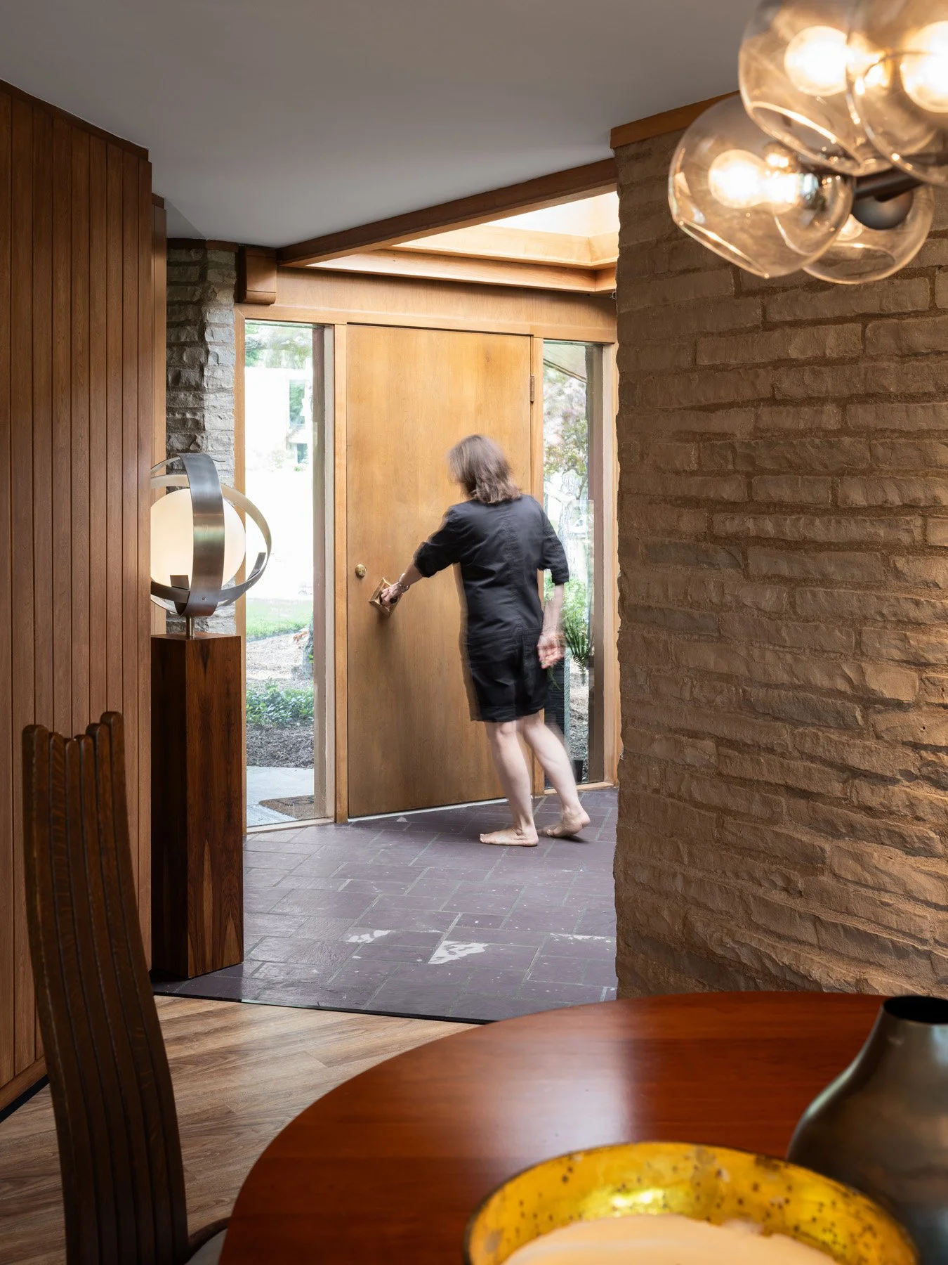 Garrison House entry foyer with slate floor and stone pier, resident at the door, Sleepy Hollow Illinois - architectural photographer Chicago