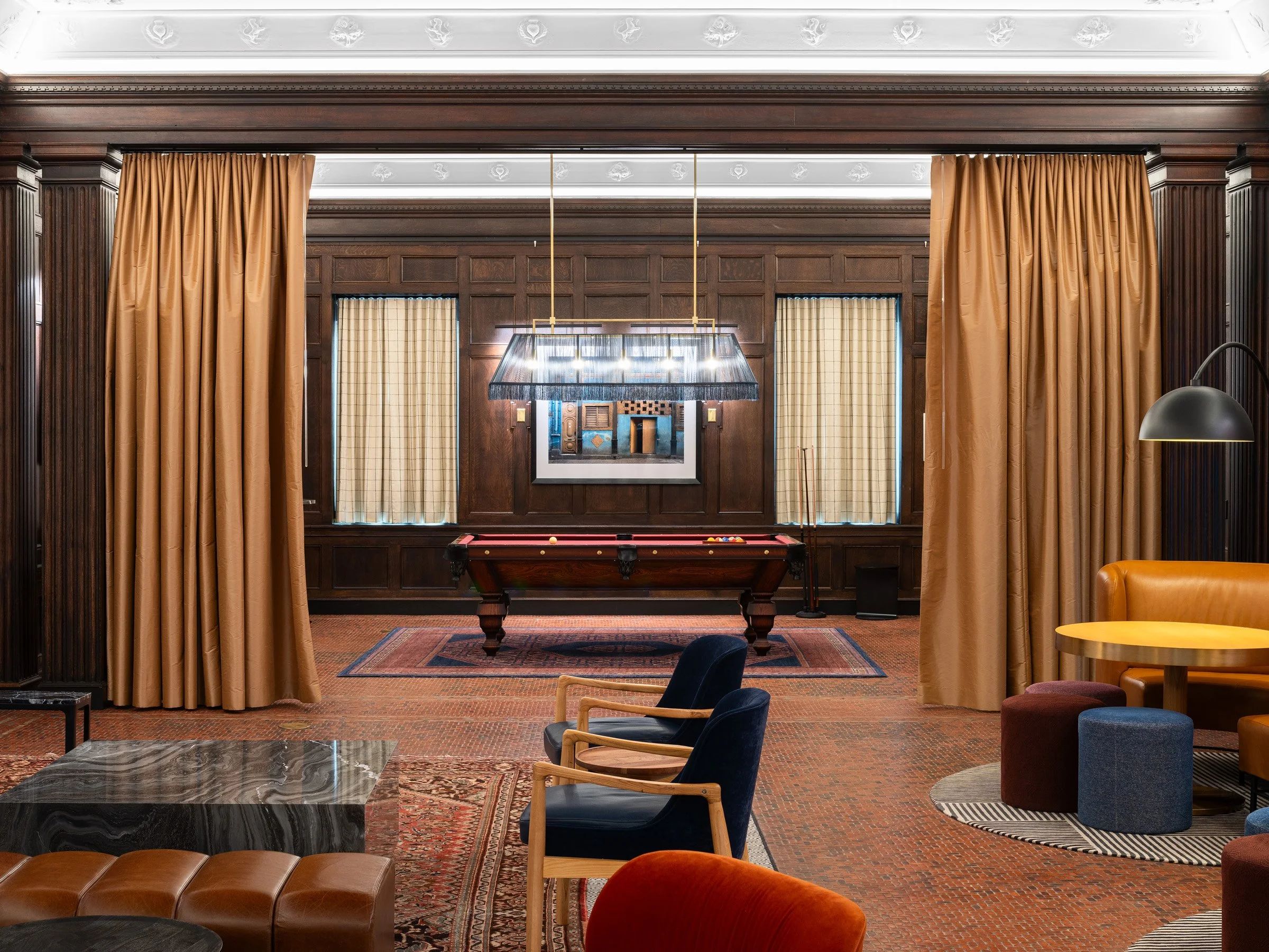 21c Museum Hotel interior billiard room with a vintage pool table beneath a fringed billiard light, framed by dark wood paneling, by Perfido Weiskopf Wagstaff + Goettel and Hufft - architectural photographer St. Louis Missouri