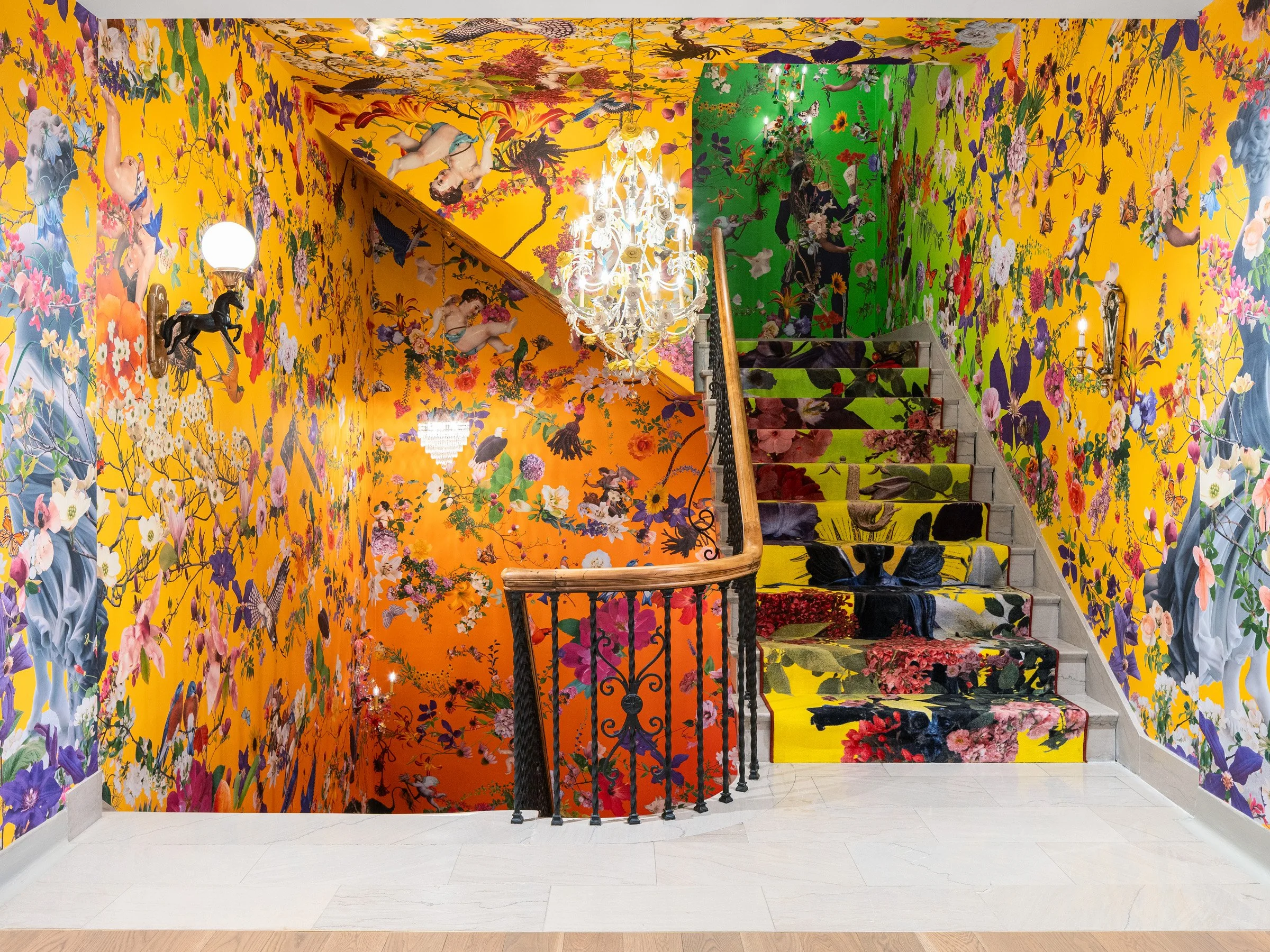 21c Museum Hotel interior feature staircase wrapped floor to ceiling in maximalist floral collage wallpaper with a patterned stair runner, by Perfido Weiskopf Wagstaff + Goettel and Hufft - architectural photographer St. Louis Missouri