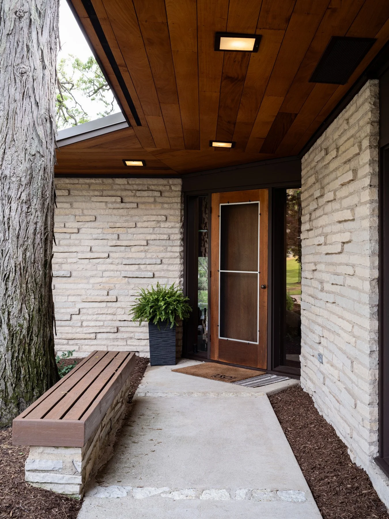 Garrison House covered entry with coursed limestone walls and wood ceiling, Sleepy Hollow Illinois - architectural photographer Chicago