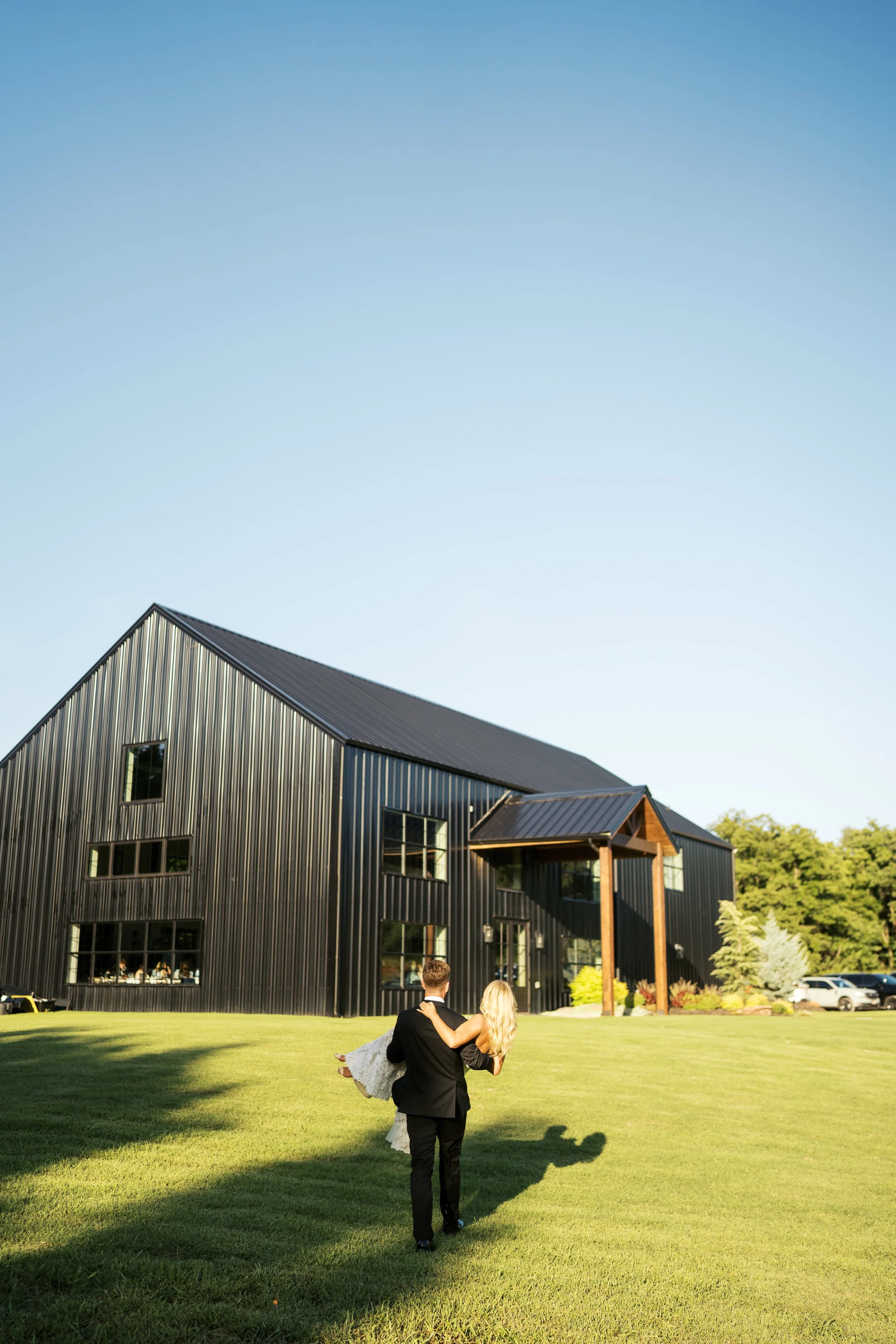 Groom carrying bride front of bldg.jpg