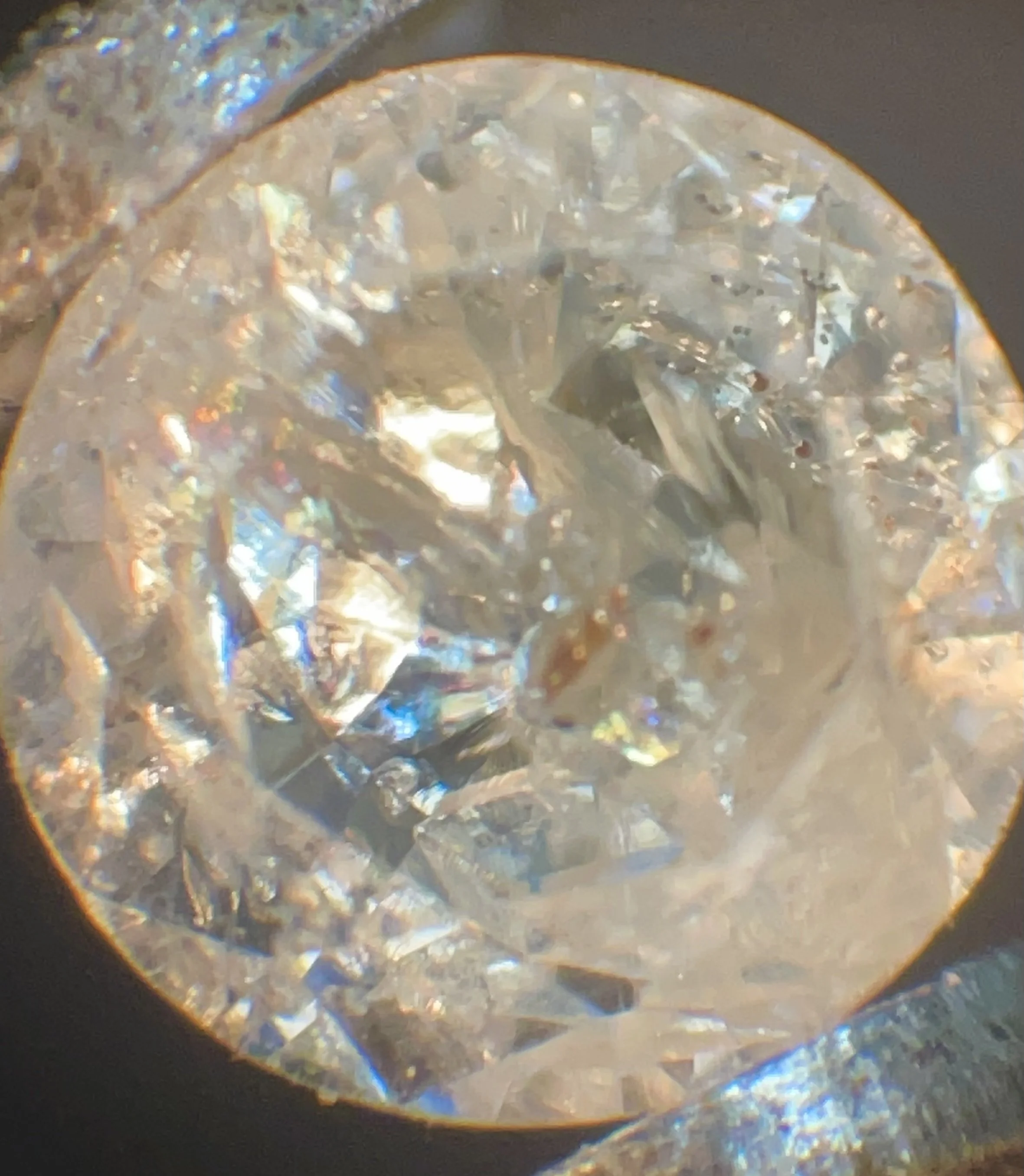 Yehuda treated diamond; take a close look at the rainbow flashes in this diamond. This enhancement is done by filling inclusions with glass and other materials to enhance clarity. It is common in the diamond trade!