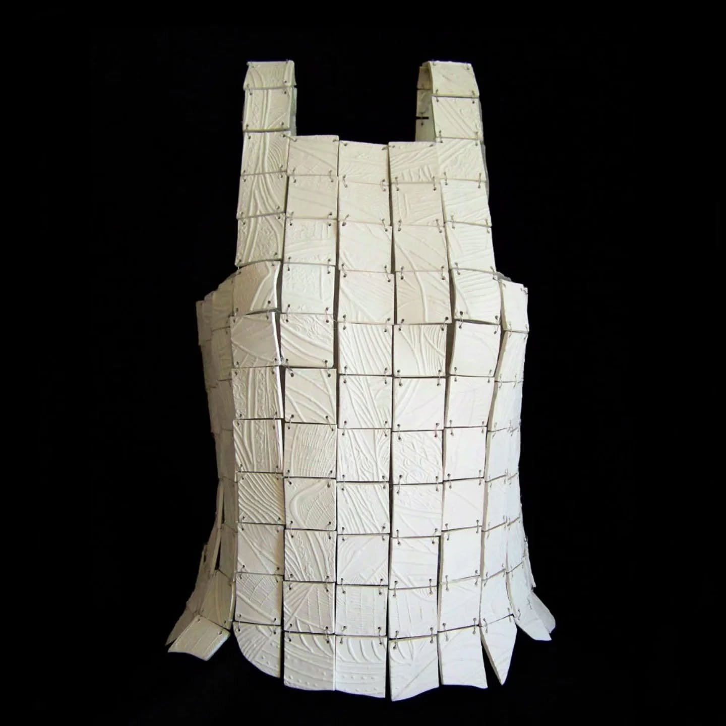 Malki Studio&rsquo;s Second Skin armour transforms life&rsquo;s experiences into wearable sculpture.

Each handcrafted ceramic tile bears delicate imprints &mdash; subtle echoes of the marks left by our journey.

Bound together with fine silver wire,