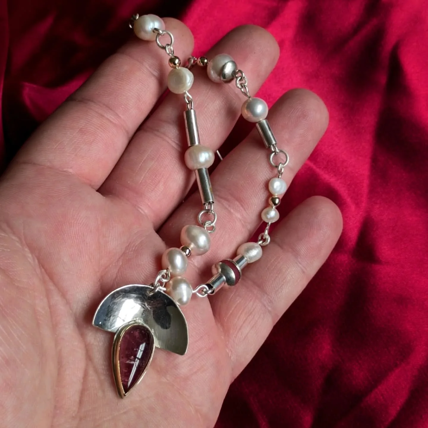 Citing the opulent colours and textures of Byzantine artistry, this necklace is a celebration of Mediterranean light and lush materials. An 8.17ct pinkish-purple Brazilian tourmaline, a ruby bead, and lustrous freshwater pearls are set in 18kt &
