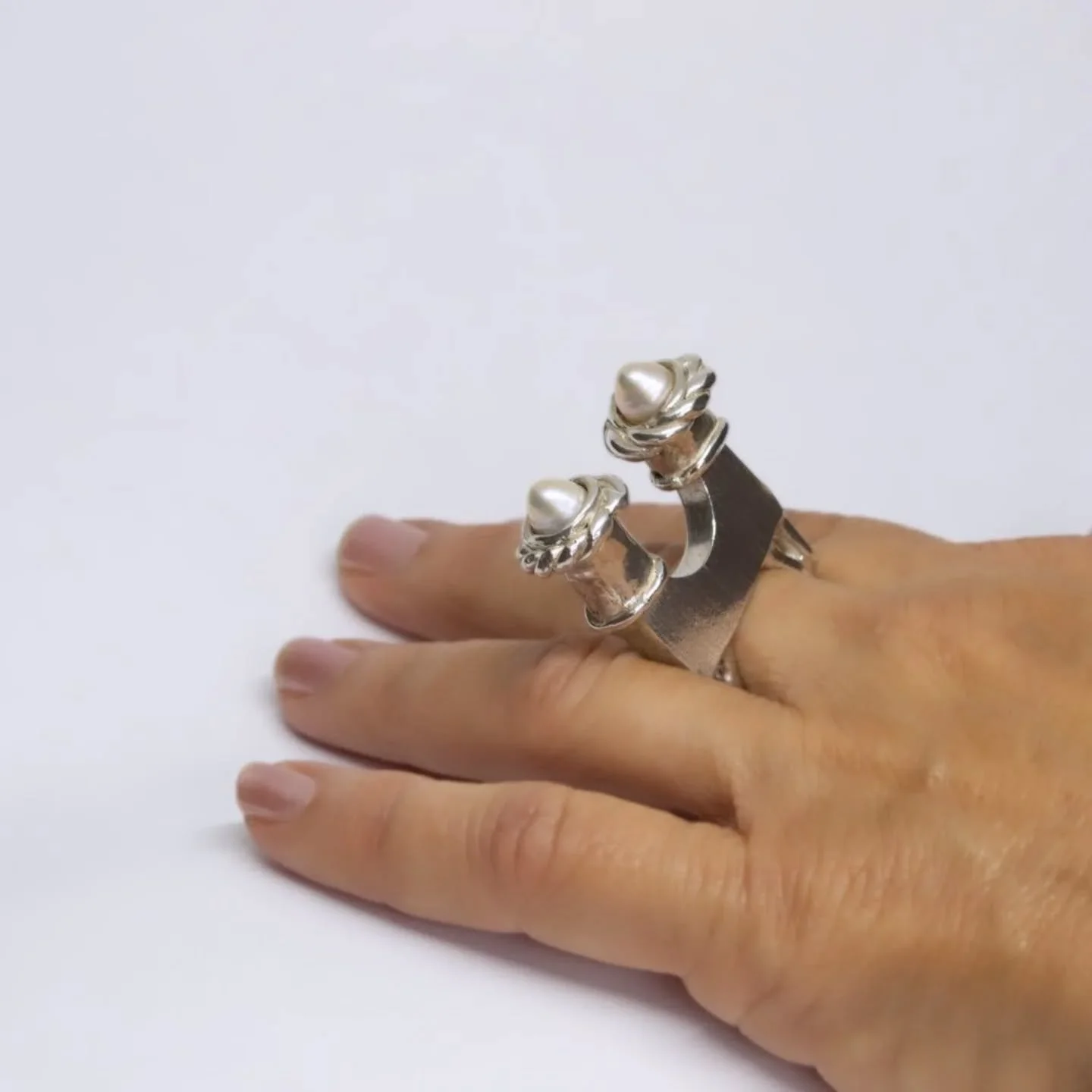 Shabbat is a unique sterling silver and freshwater pearls ring made by lost wax casting. It features two tall stems crowned by lustrous pearls that create a glow reminiscent of the traditional Shabbat candles.

Shabbat shalom.

www.malkistudio.com/sh