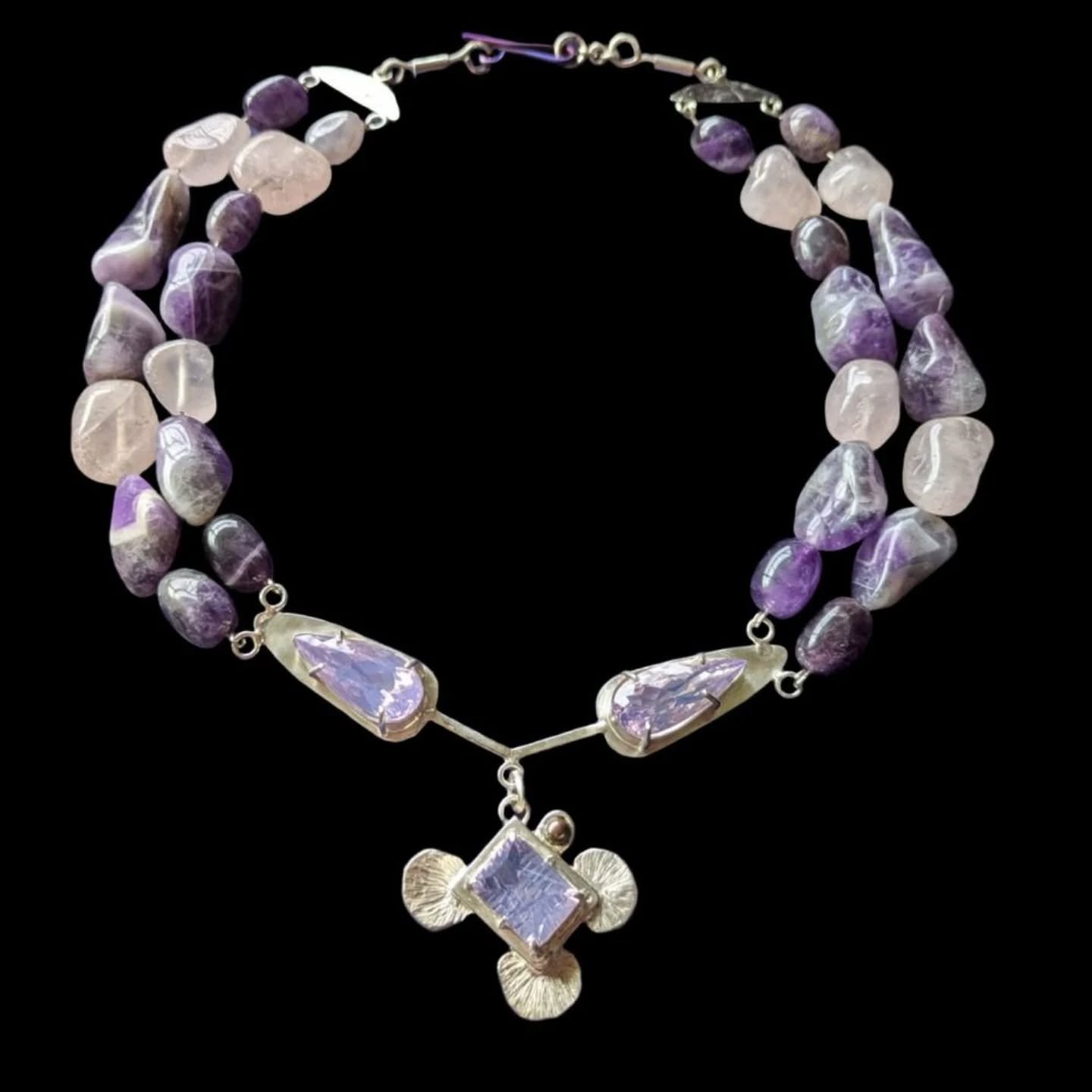 Ester &mdash; named after Queen Esther of Ancient Persia.

Soft tones of lavender quartz, rose quartz, chevron amethyst, and a dark freshwater pearl come together in a piece that feels both powerful and deeply feminine. 

Handcrafted in sterling silv