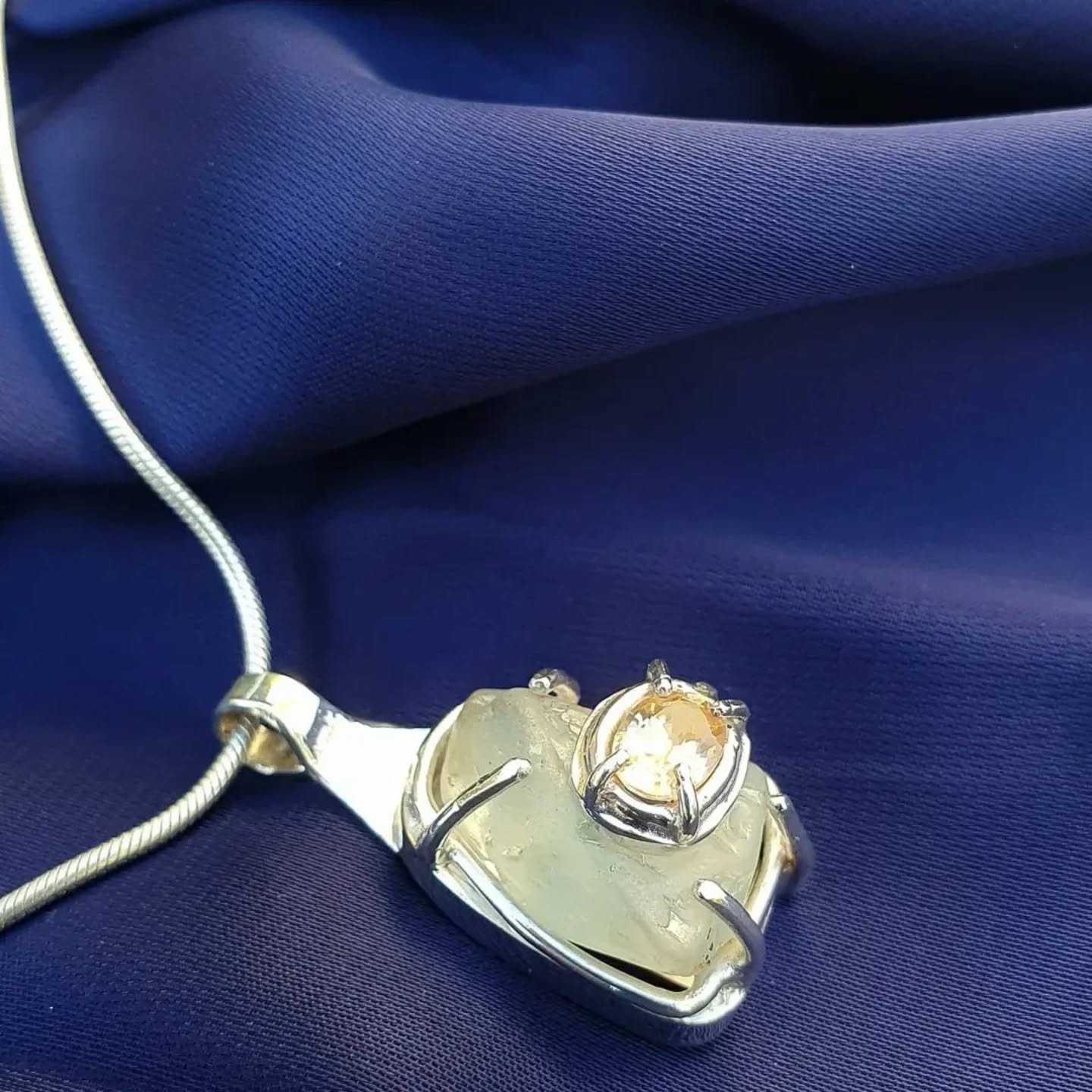 Explore the @bundabergregionalgalleries latest exhibitions and new gallery-shop stock including our new pendant necklace. It combines two ethically-sourced Australian gemstones, a rough light blue Topaz and natural oval-cut champagne Zircon, set in r