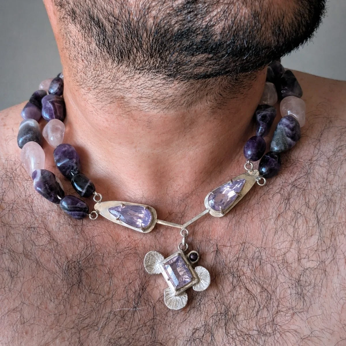 elegant purple gemstone necklace on male chest.jpg