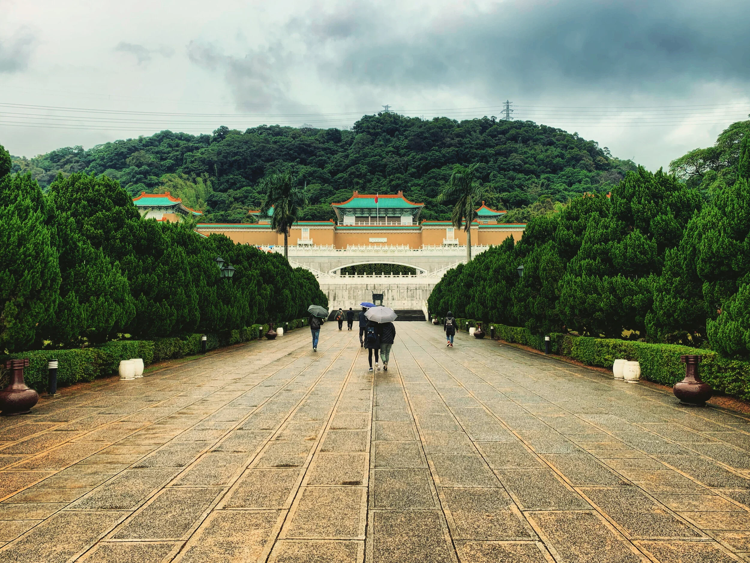 TAIPEI, TAIWAN - DECEMBER 5, 2019: Visitors approaching the entrance of the National Palace Museum on a rainy morning.