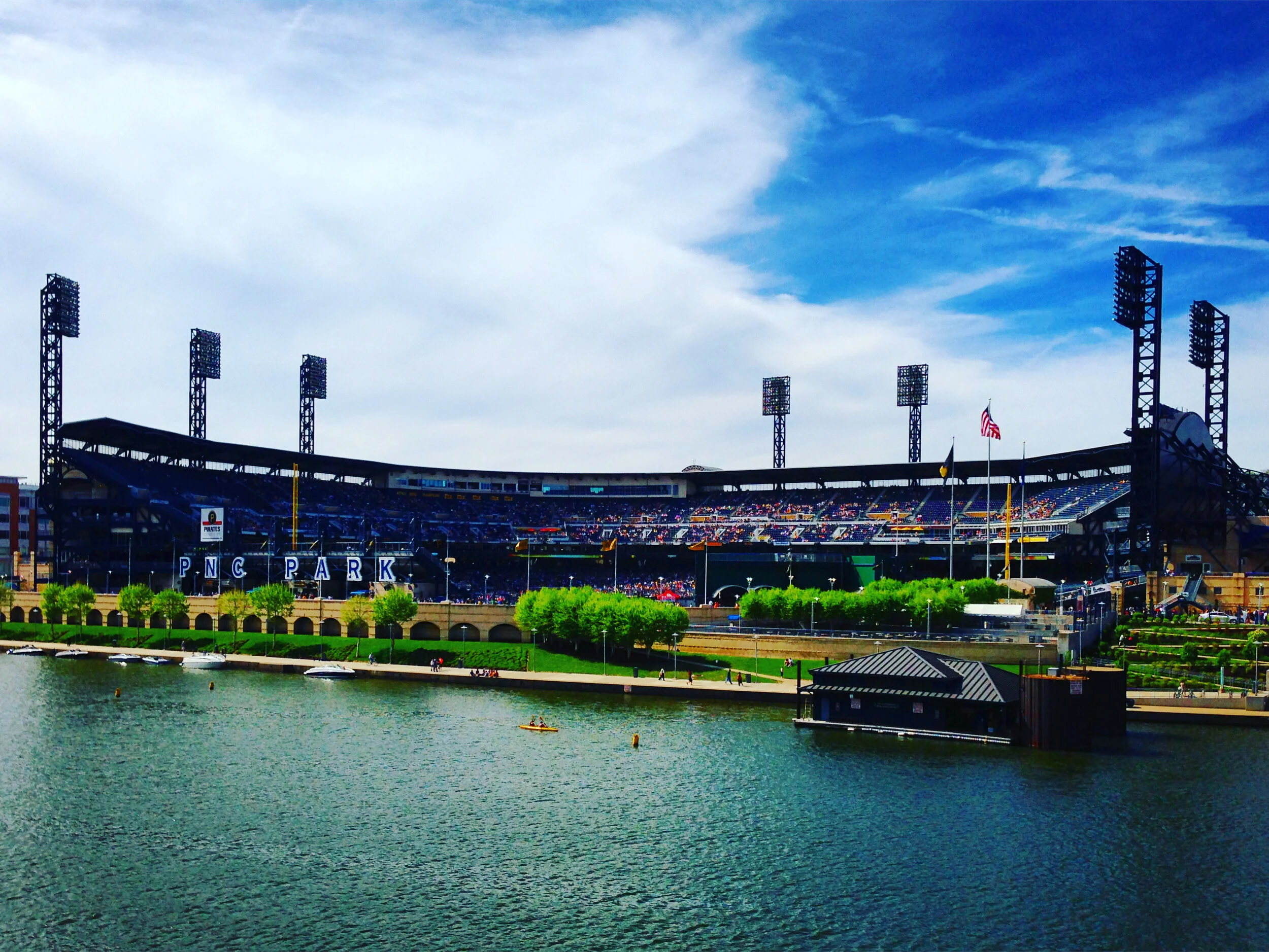 PITTSBURGH, PA - MAY 4, 2013: Kayakers float along the Allegheny River as fans enter PNC Park for a late Saturday afternoon game between the Washington Nationals and the Pittsburgh Pirates.