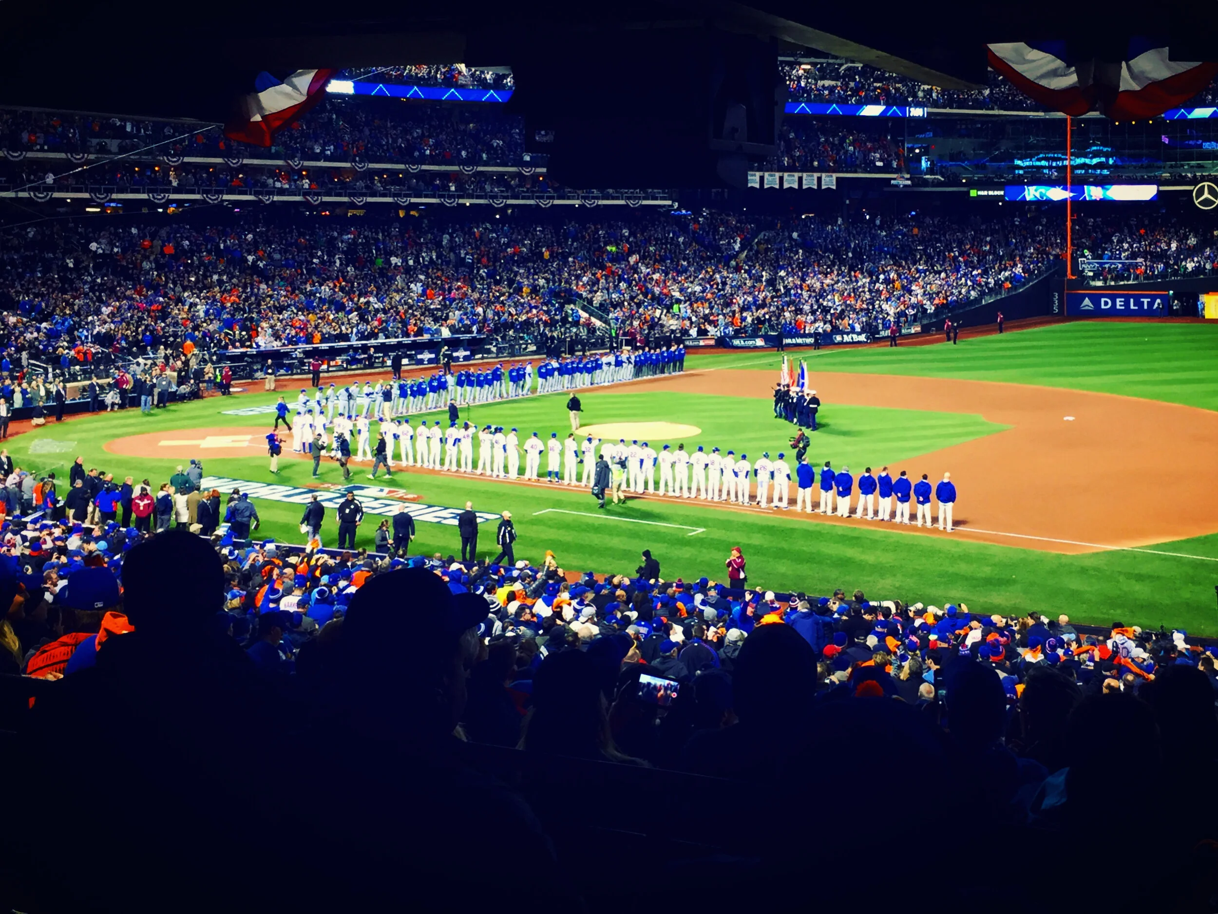 FLUSHING, NY - OCTOBER 30, 2015: The National League Champion New York Mets line up along the first base line for the National Anthem prior to Game 3 of the 2015 World Series.
